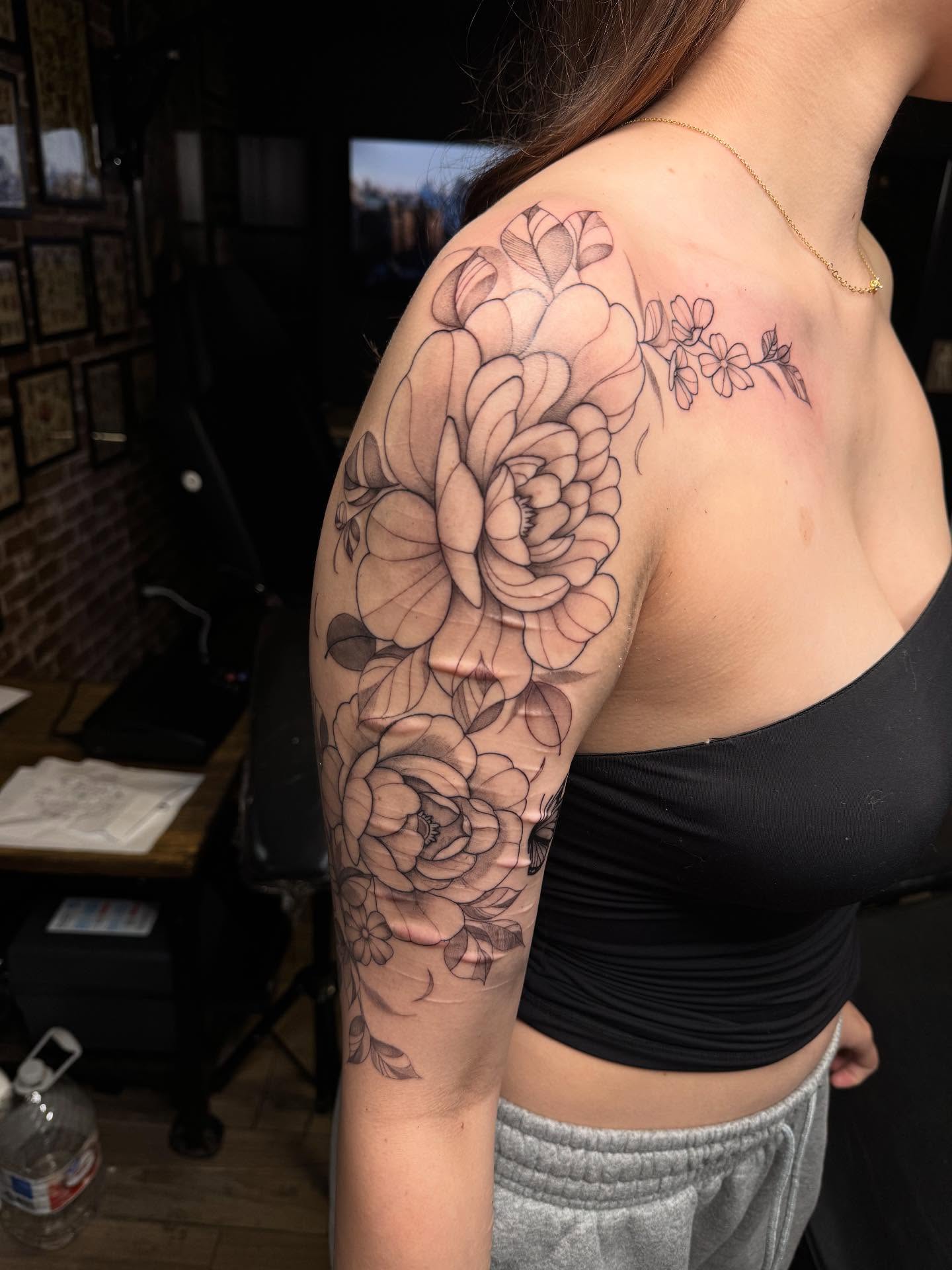 Floral bouquet black and grey tattoo on the shoulder by Mickey