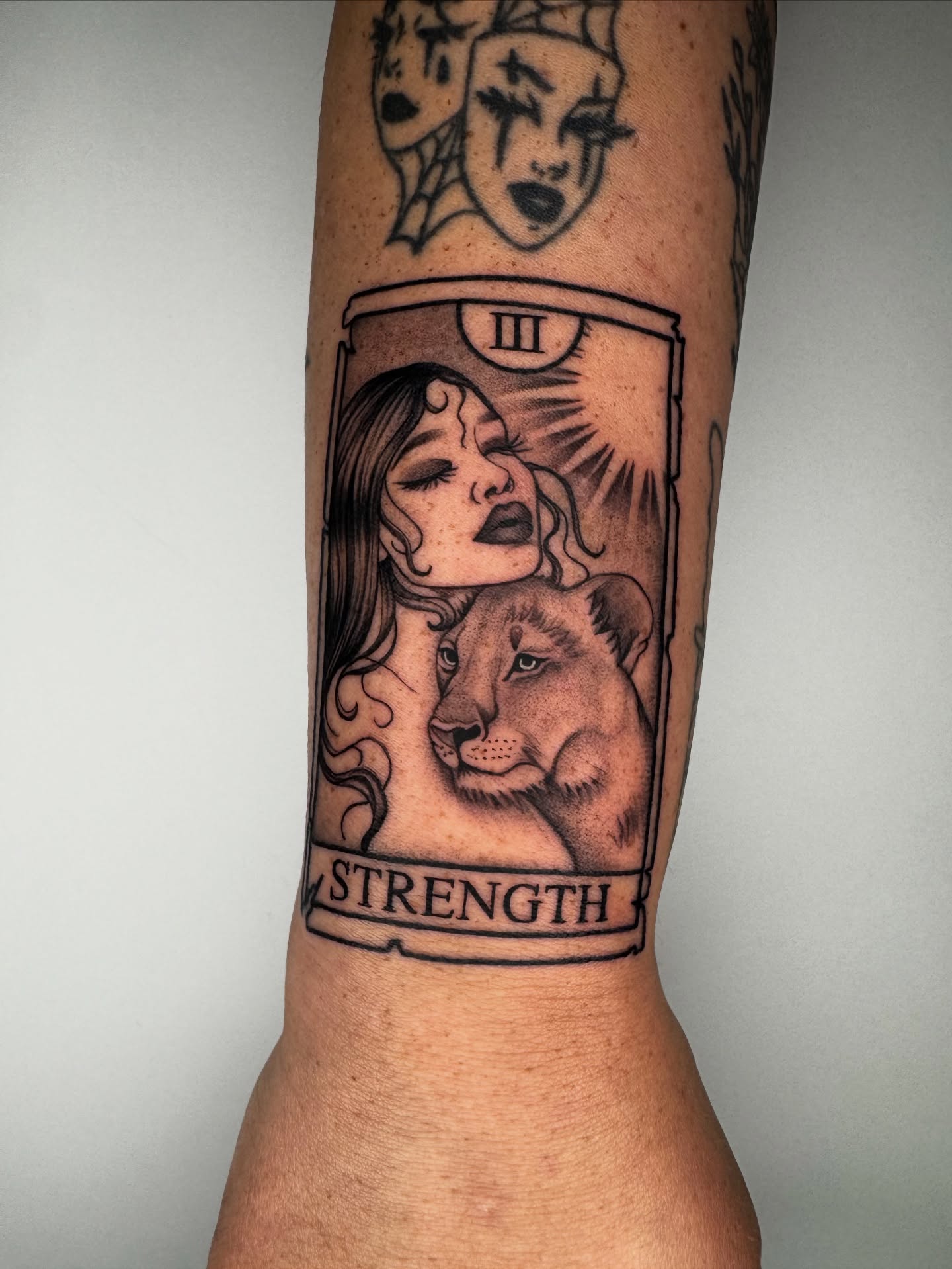Strength card black and grey tattoo on the forearm by Austin Tattoo Artist, Austin, Texas