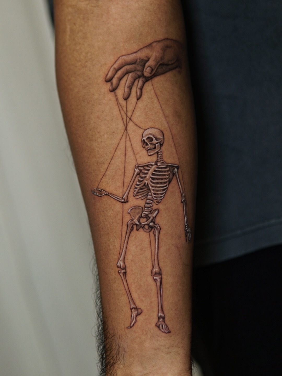 Marionette skeleton realism tattoo on the forearm by Ray Quinday