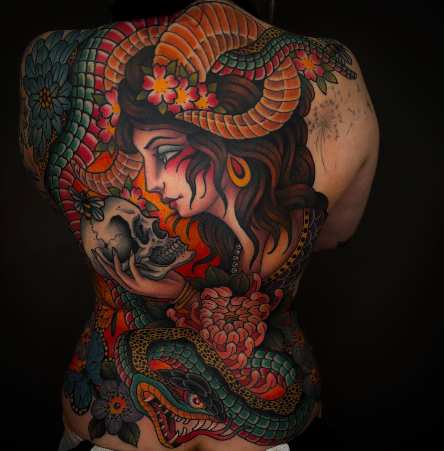 Woman with skull American traditional tattoo on the back by Cody Collins