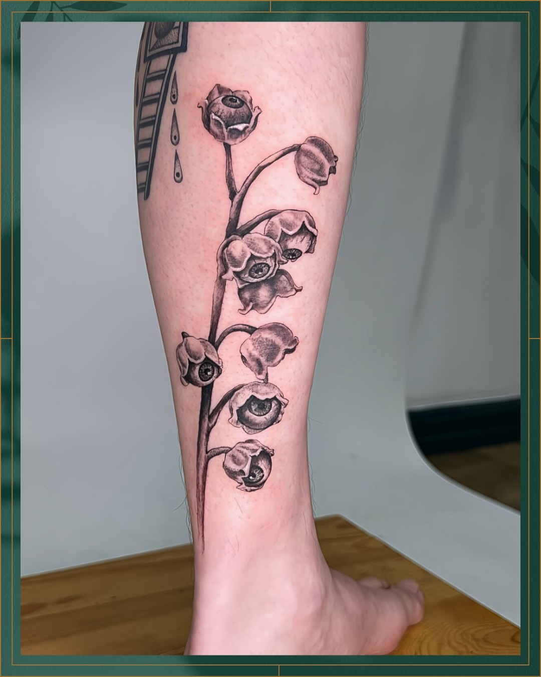 Lily of the valley black and grey tattoo on the calf by Tiffany