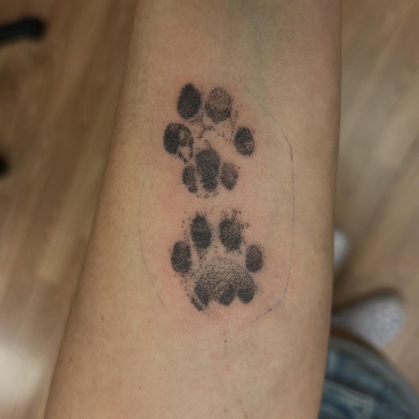 Paw print dotwork tattoo on the forearm by Chris