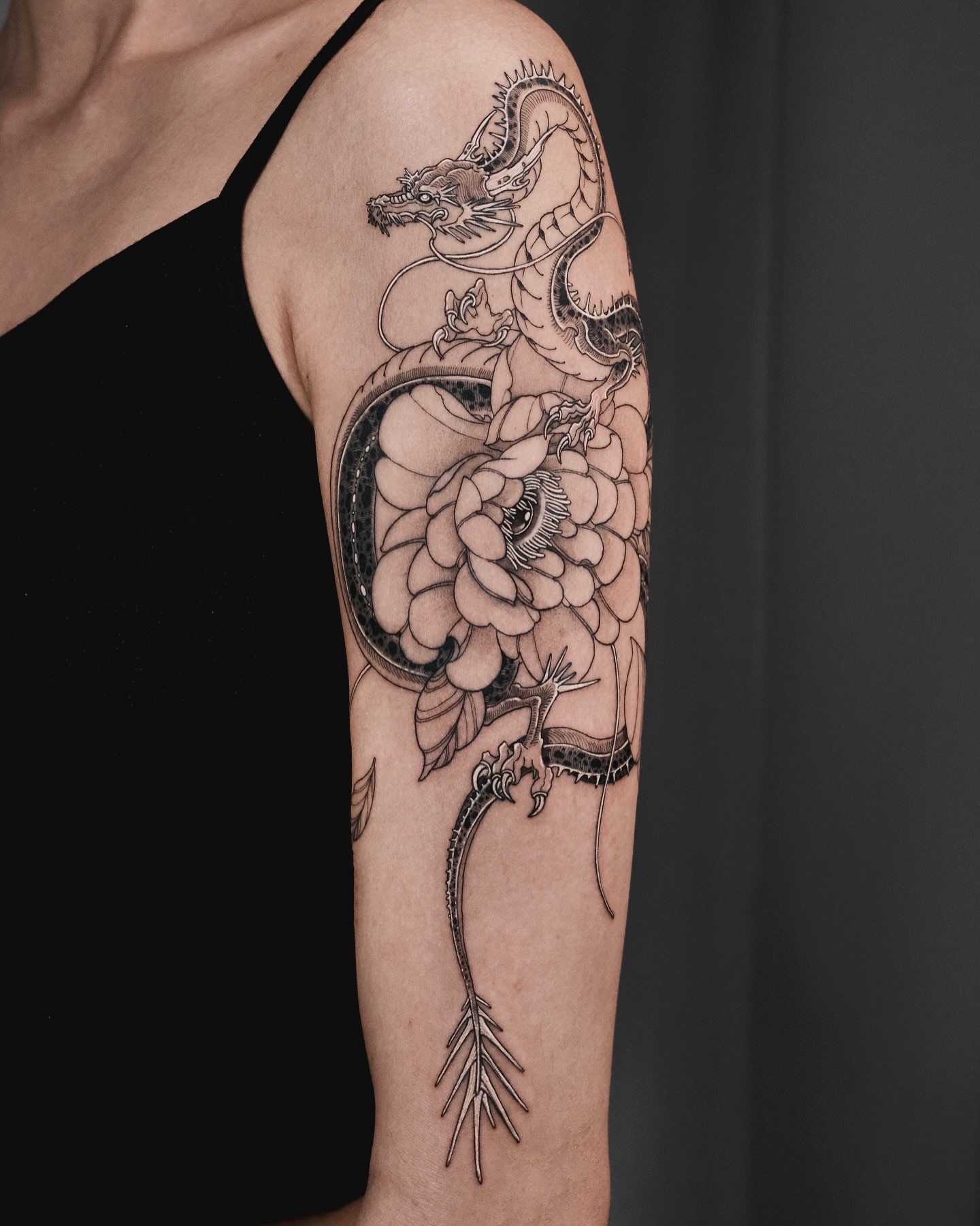 Dragon and flower realism tattoo on the forearm by p o b i