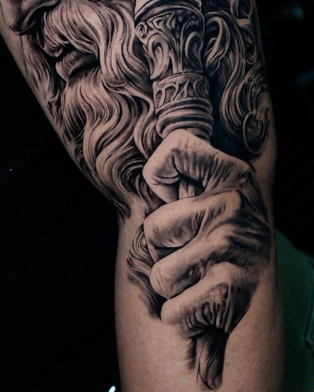 Bearded man holding staff realism tattoo on the forearm by Elisha Kane