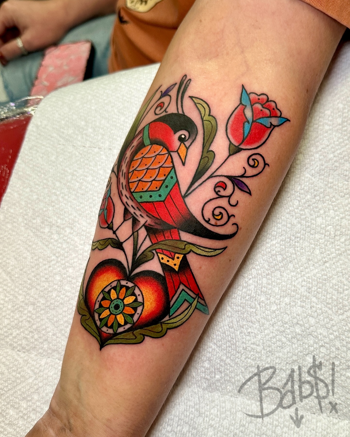 Bird and floral American traditional tattoo on the forearm by Justin B