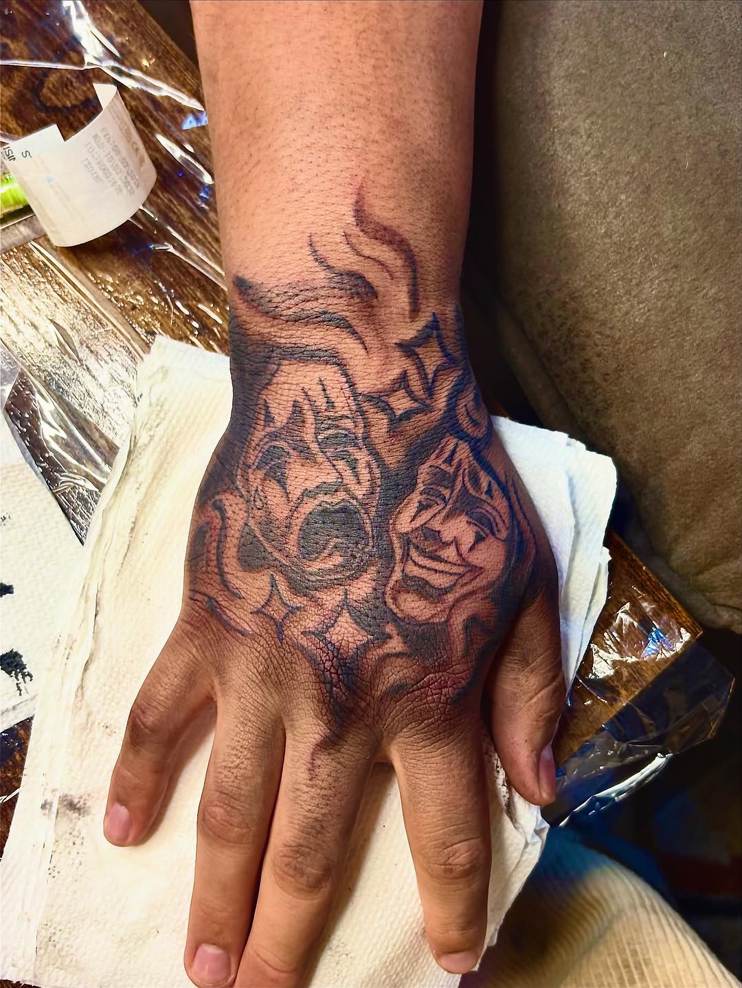 Comedy and tragedy masks realism tattoo on the hand by sams tattoos