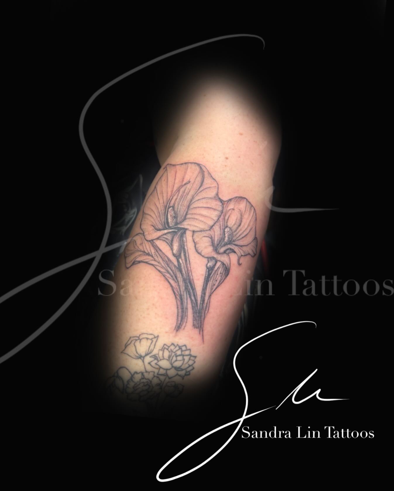 Calla lilies black and grey tattoo on the forearm by Sandra Lin Cue