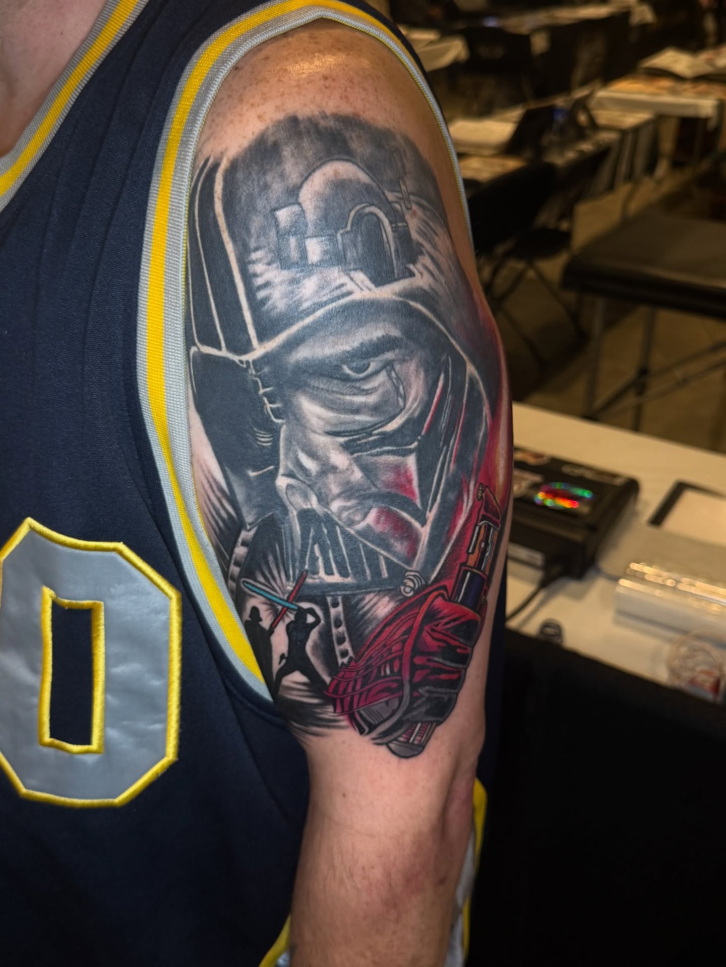 Firefighter helmet realism tattoo on the upper arm by Emac, Baltimore, Maryland