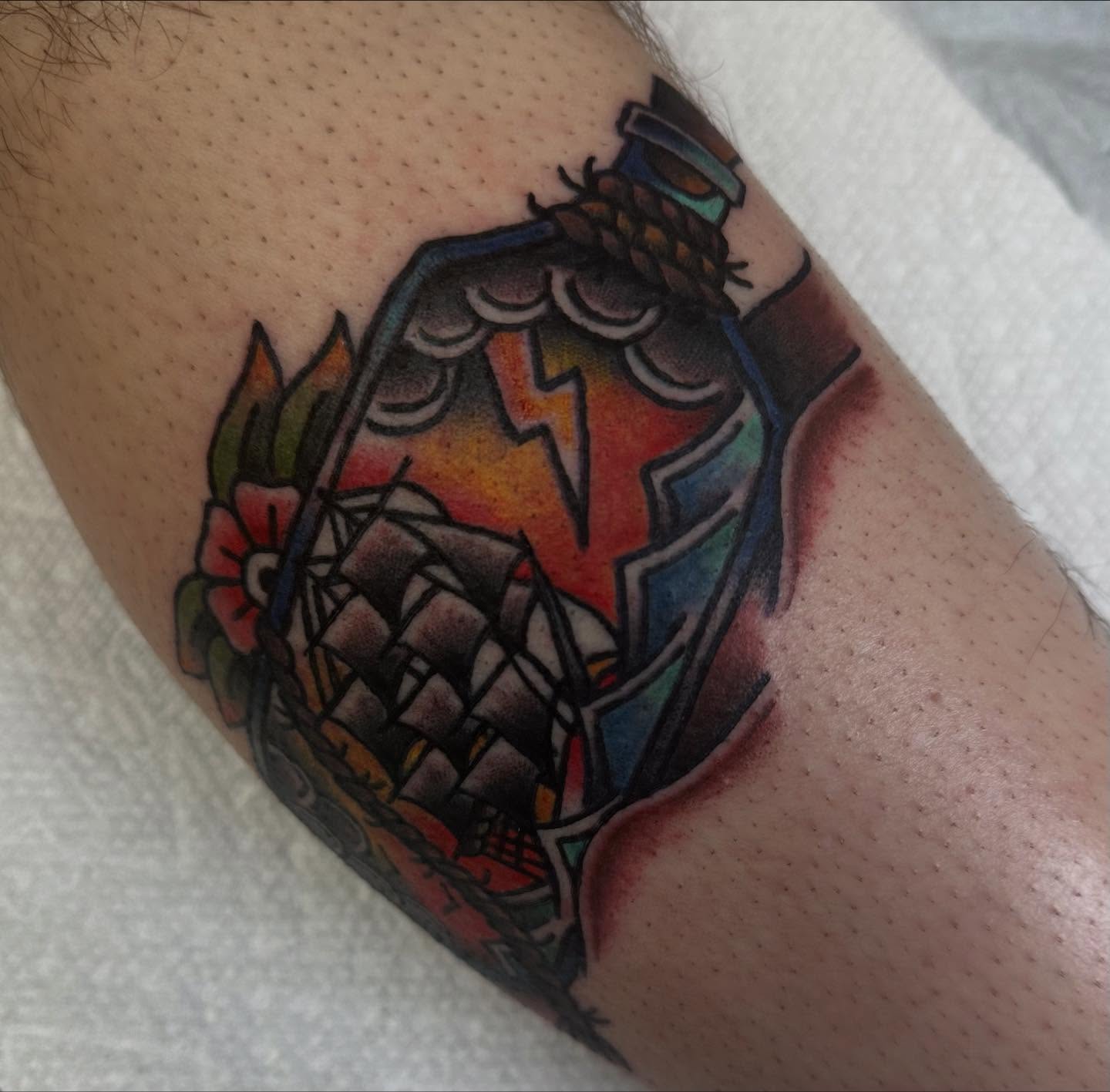 Pinecone and lightning bolt American traditional tattoo on the forearm by norawillstattoo