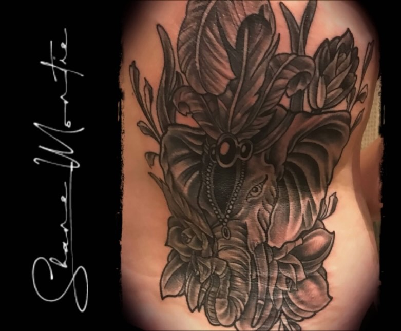 Elephant with floral crown black and grey tattoo on the shoulder by Shane Montie, Killeen, Texas