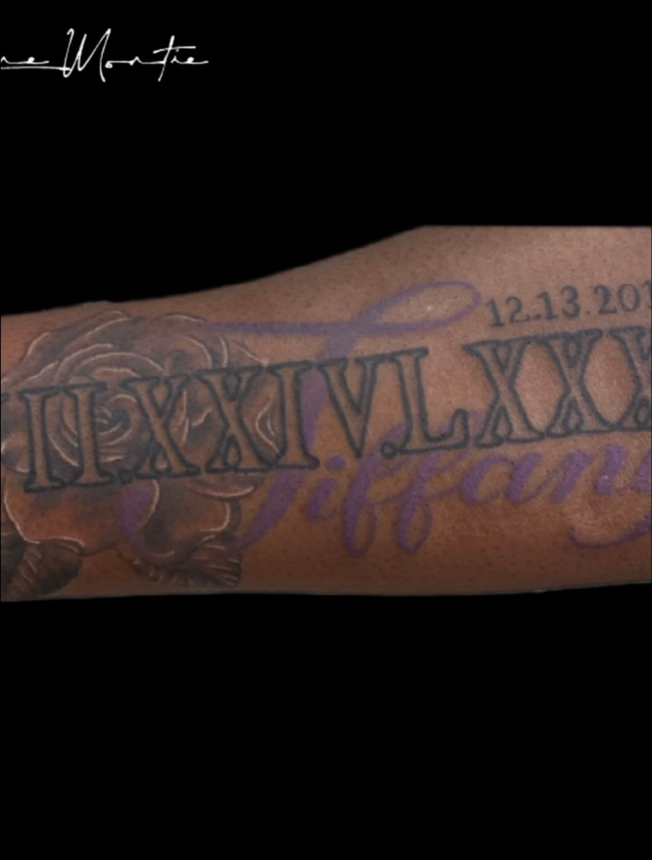 Roman numerals and name black and grey tattoo on the forearm by Shane Montie, Killeen, Texas