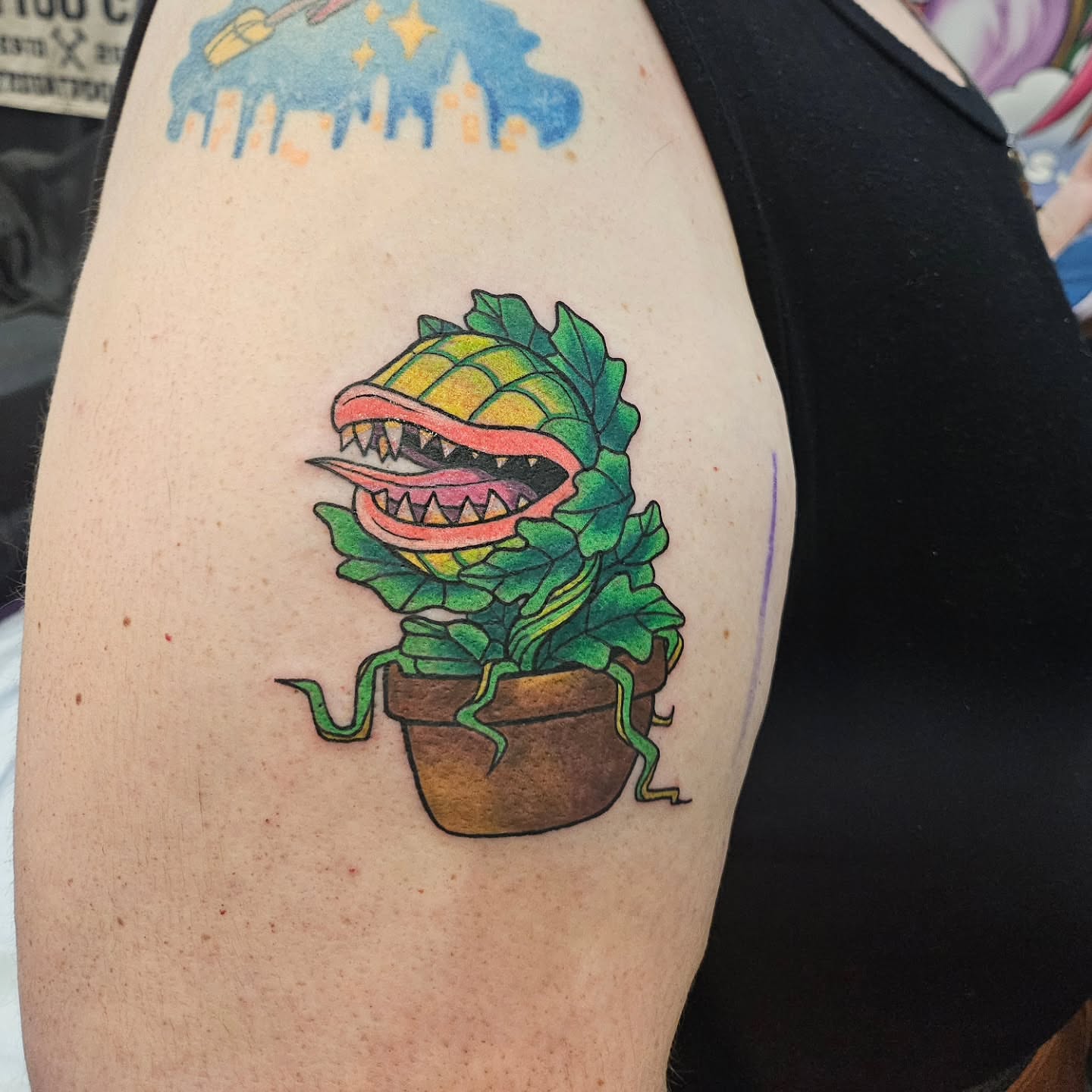 Plant monster new school tattoo on the upper arm by Gray