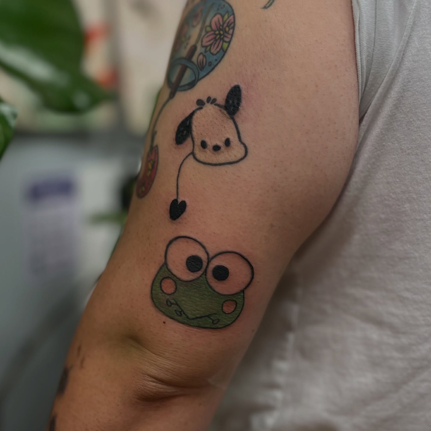 Frog and dog dotwork tattoo on the forearm by Garden Glow Tattoo