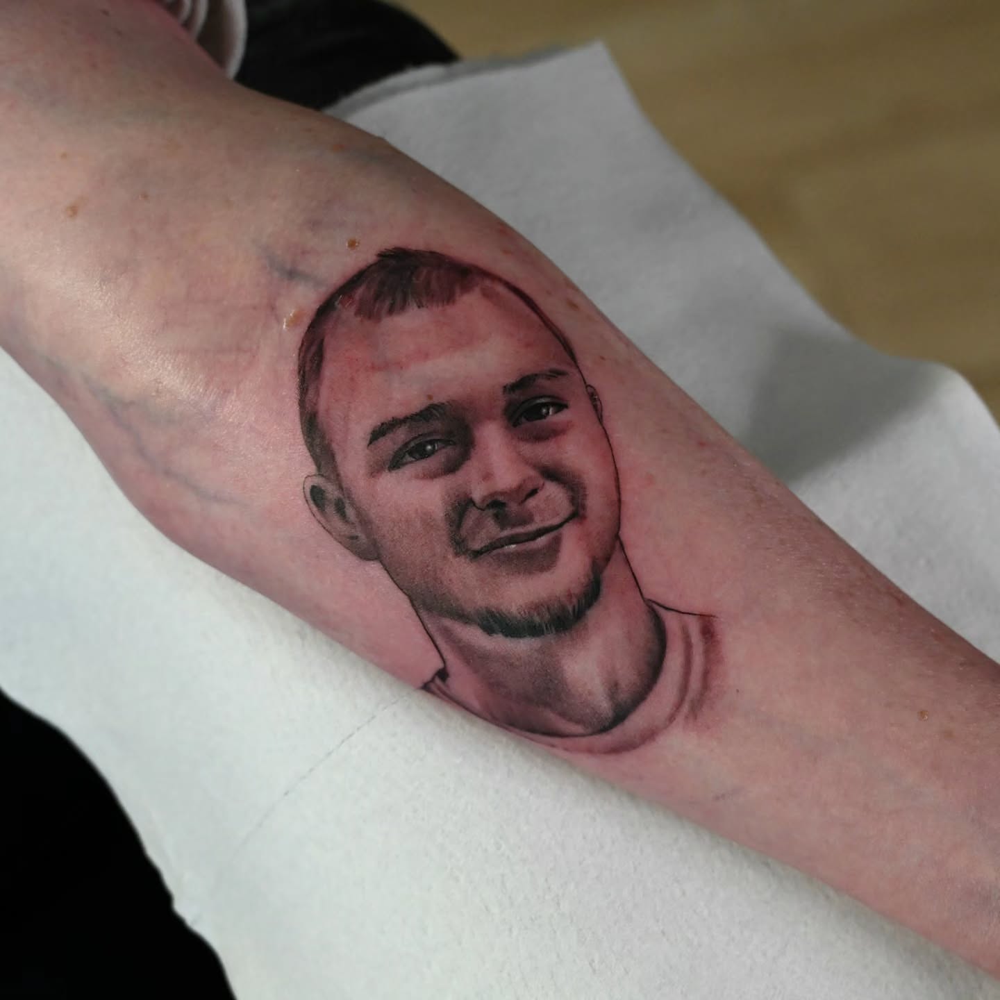 Portrait realism tattoo on the forearm by Michael ORegan