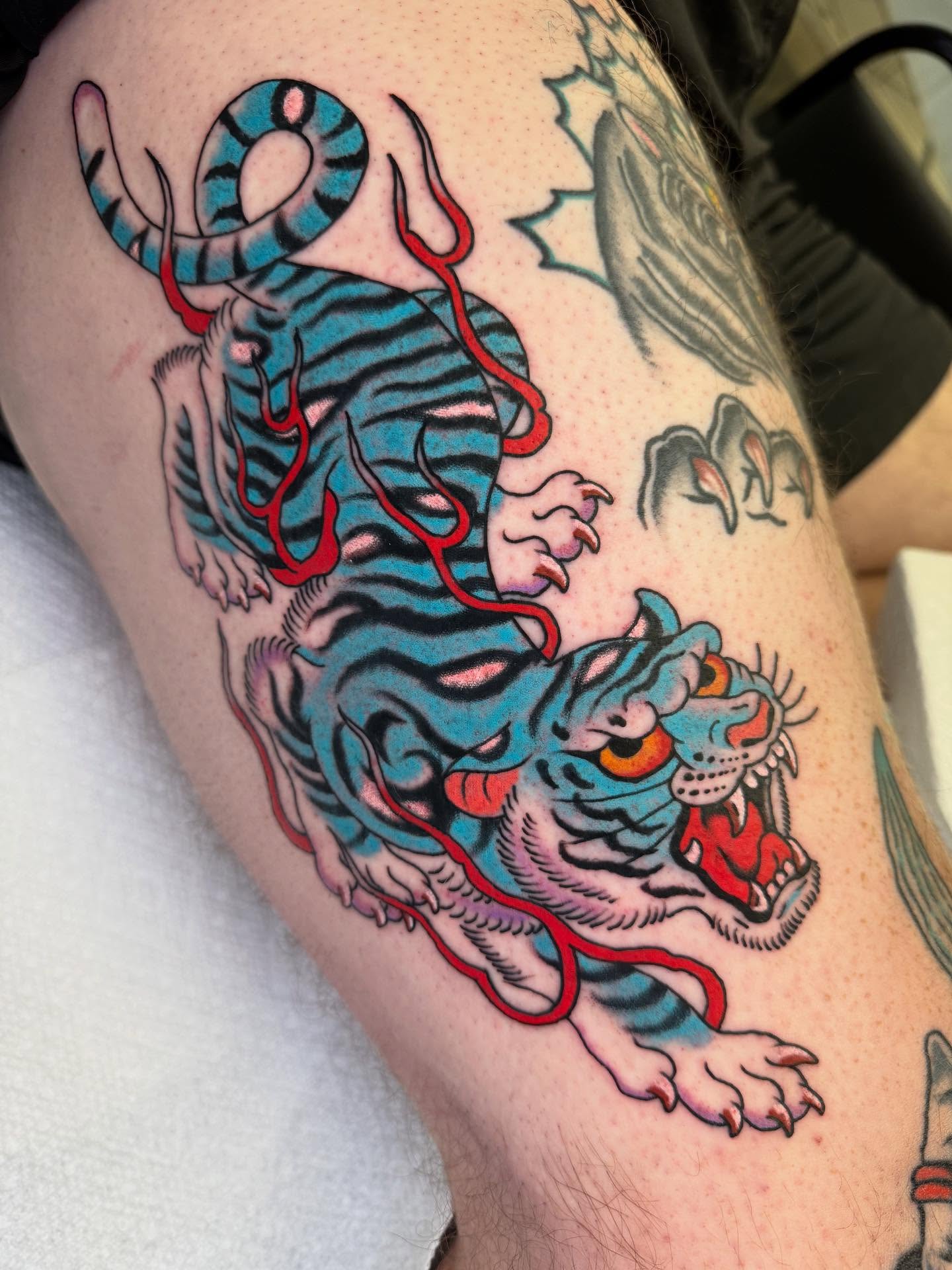 Tiger American traditional tattoo on the thigh by Cody Petkus