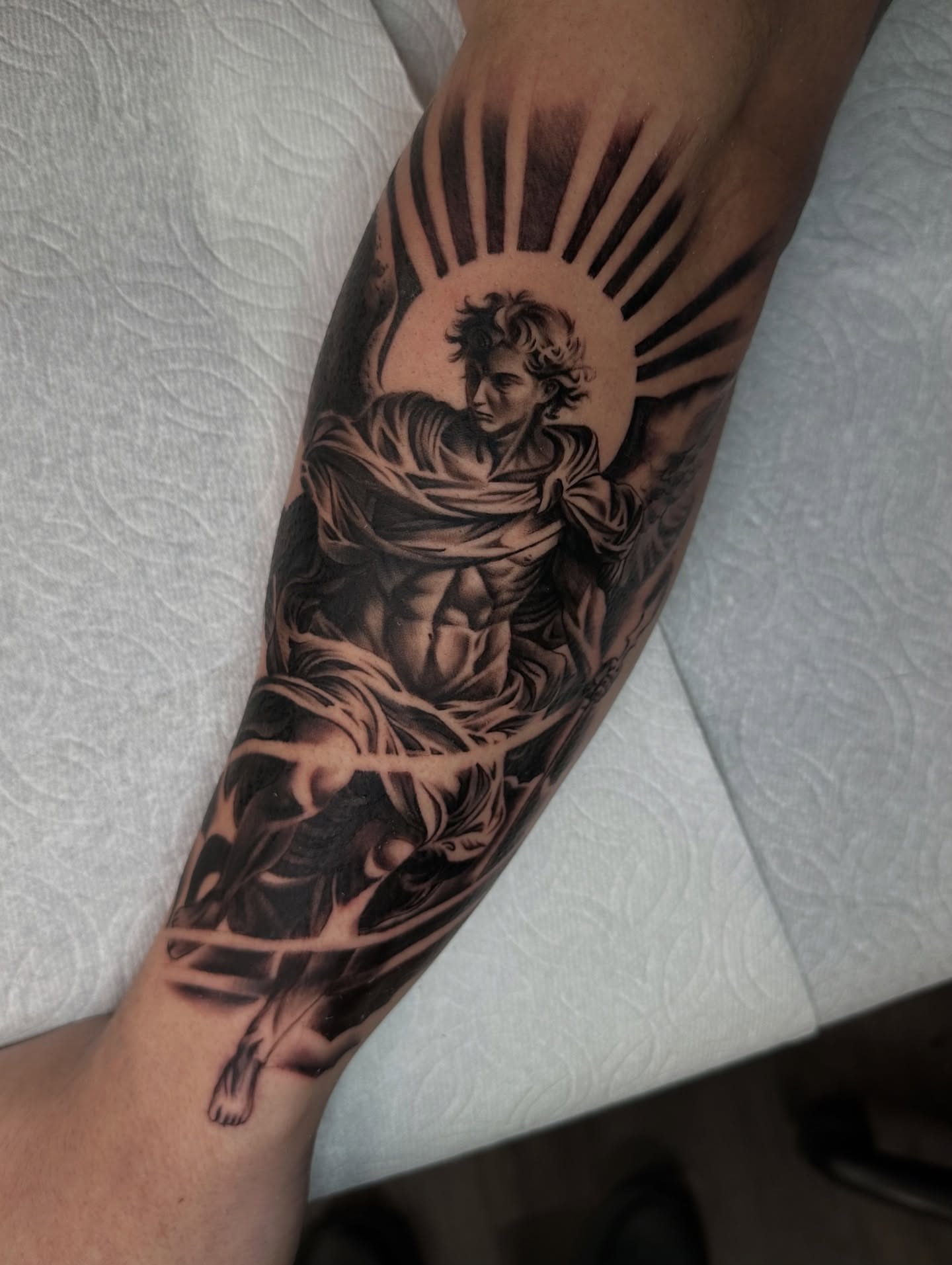 Angelic figure realism tattoo on the forearm by Mando