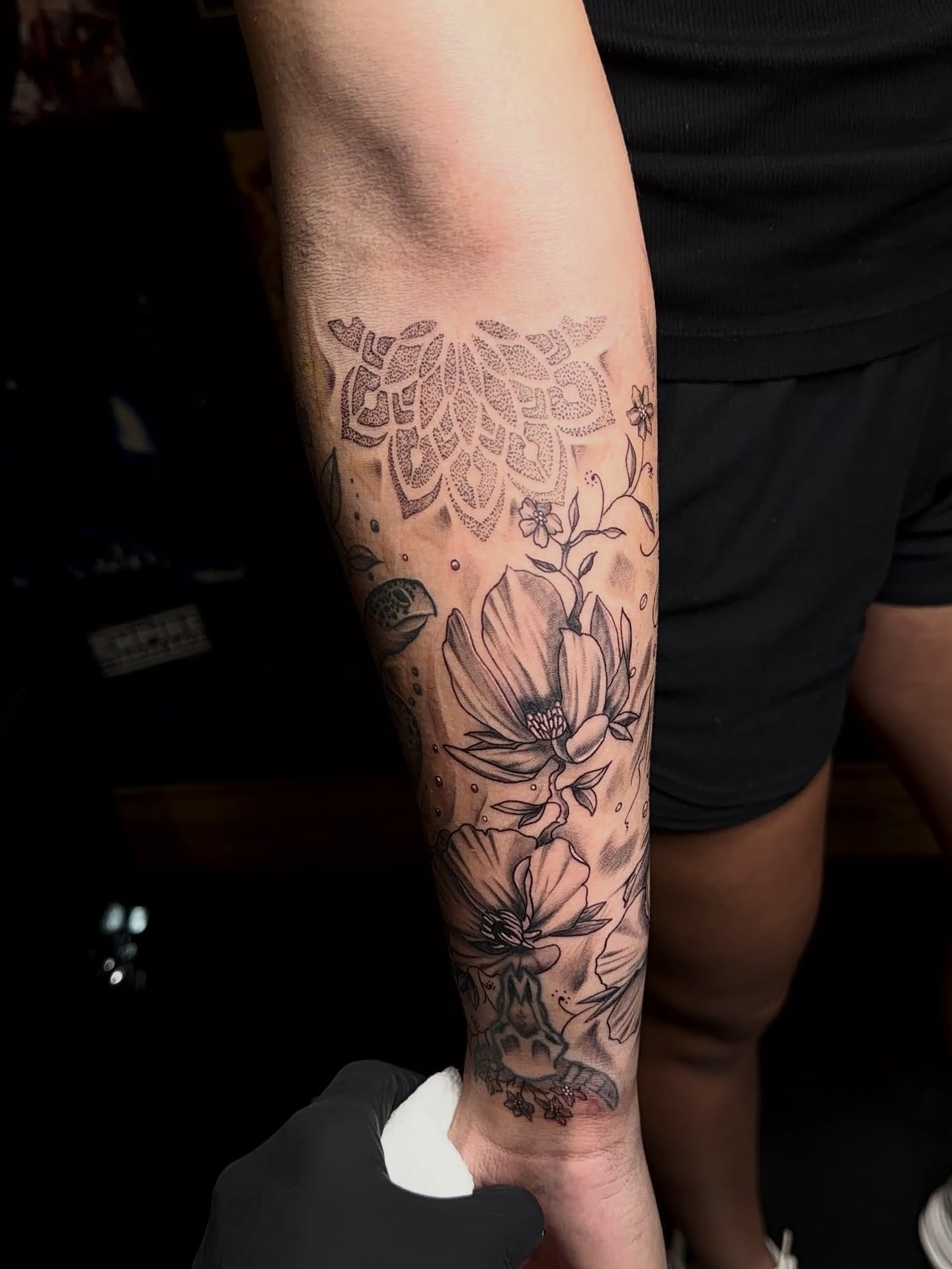 Floral design dotwork tattoo on the forearm by Denis Seregin