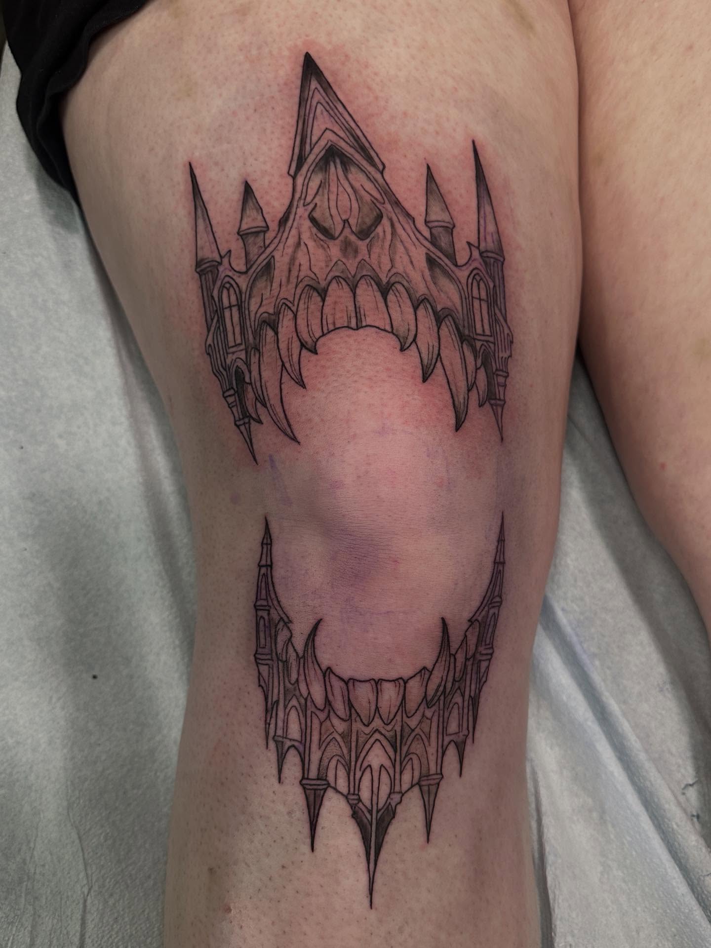 Castle black and grey tattoo on the thigh by Mika'la Berry