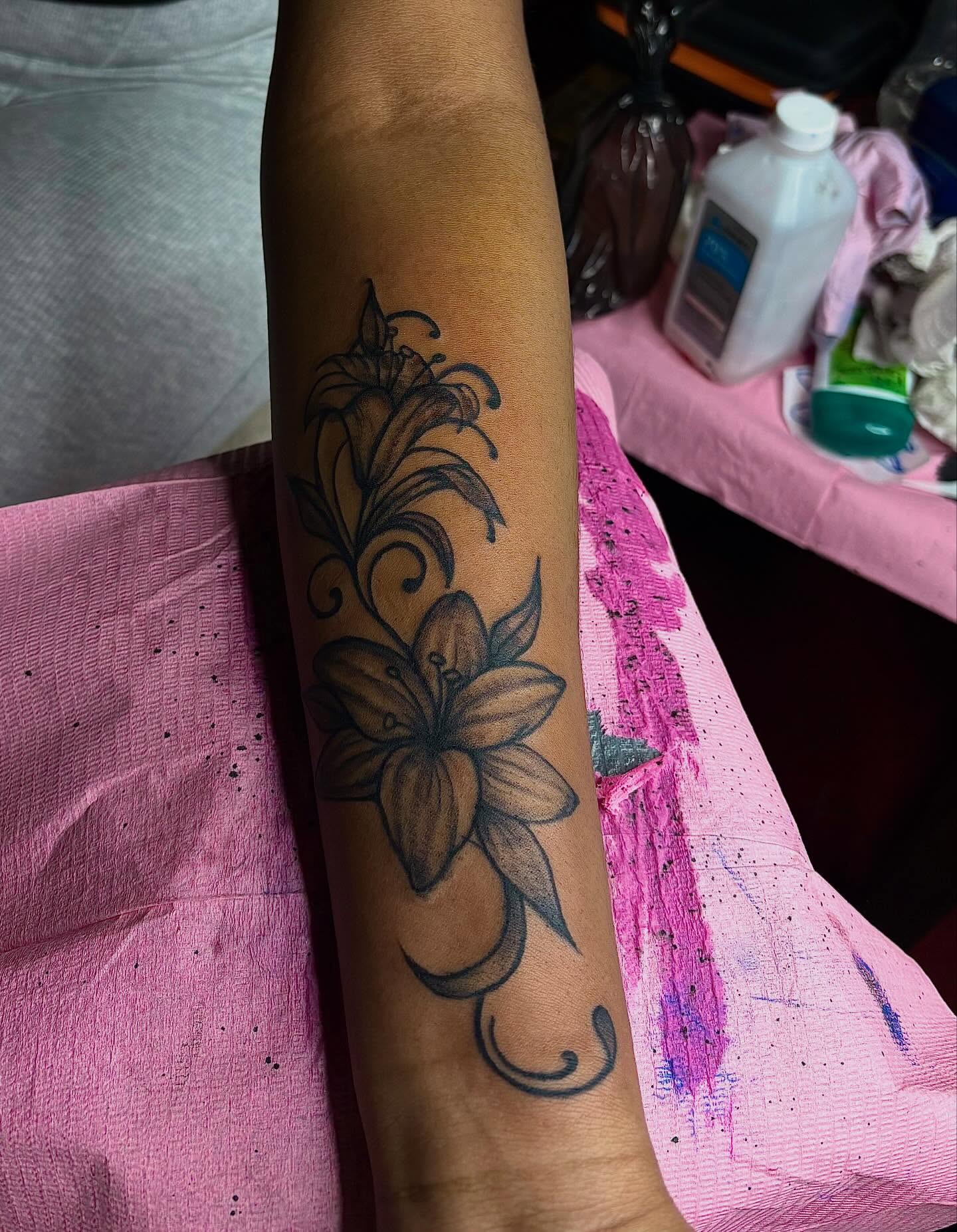 Lily black and grey tattoo on the forearm by Barbinks Studio🎀