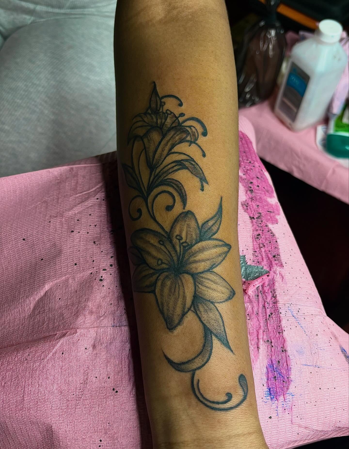 Lily black and grey tattoo on the forearm by Barbinks Studio🎀