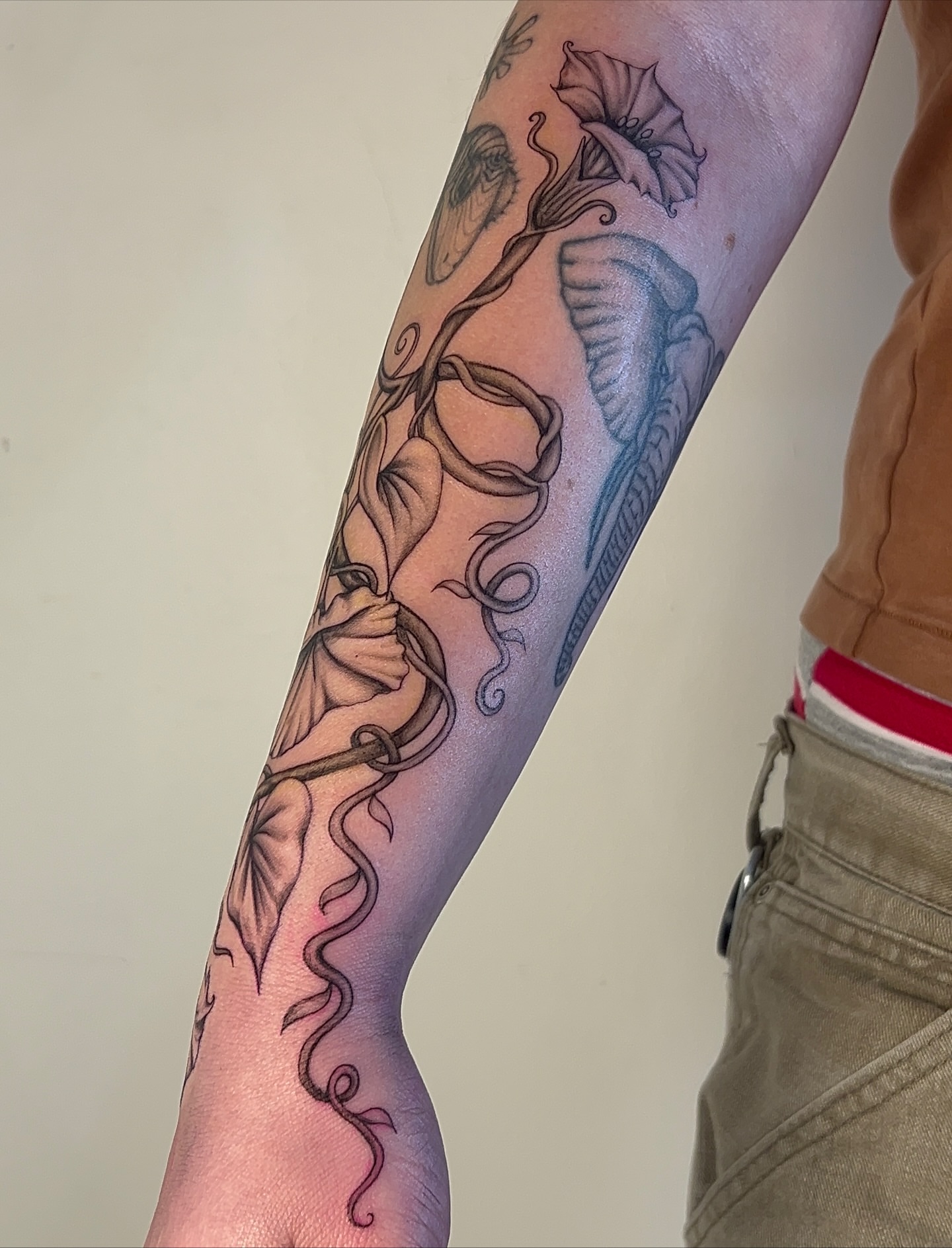 Calla lilies black and grey tattoo on the forearm by ༻𝐓𝐡𝐞 𝐒𝐤𝐢𝐧 𝐆𝐚𝐫𝐝𝐞𝐧༺