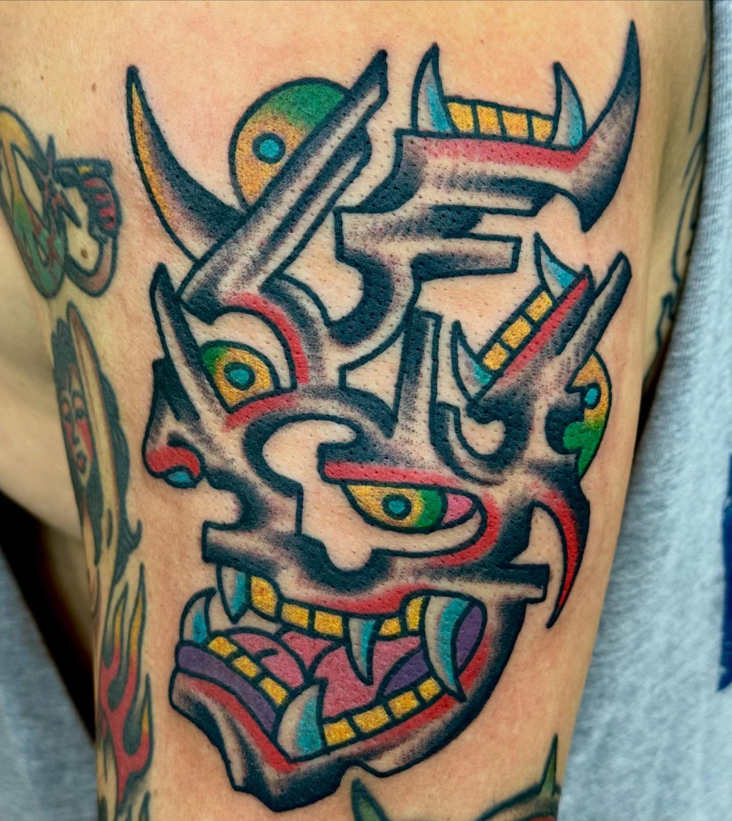 Demon mask American traditional tattoo on the forearm by Sam Hambrick, Watchung NJ
