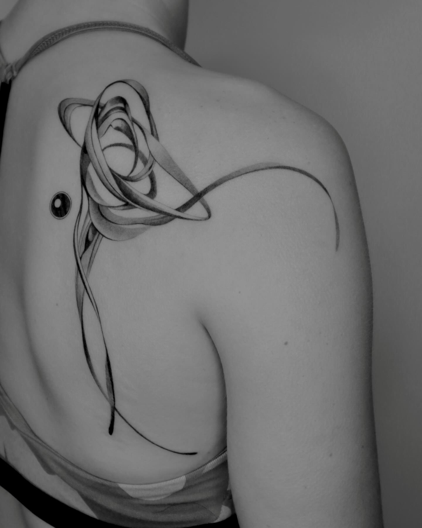 Abstract ribbon geometric tattoo on the shoulder by River, New York, New York