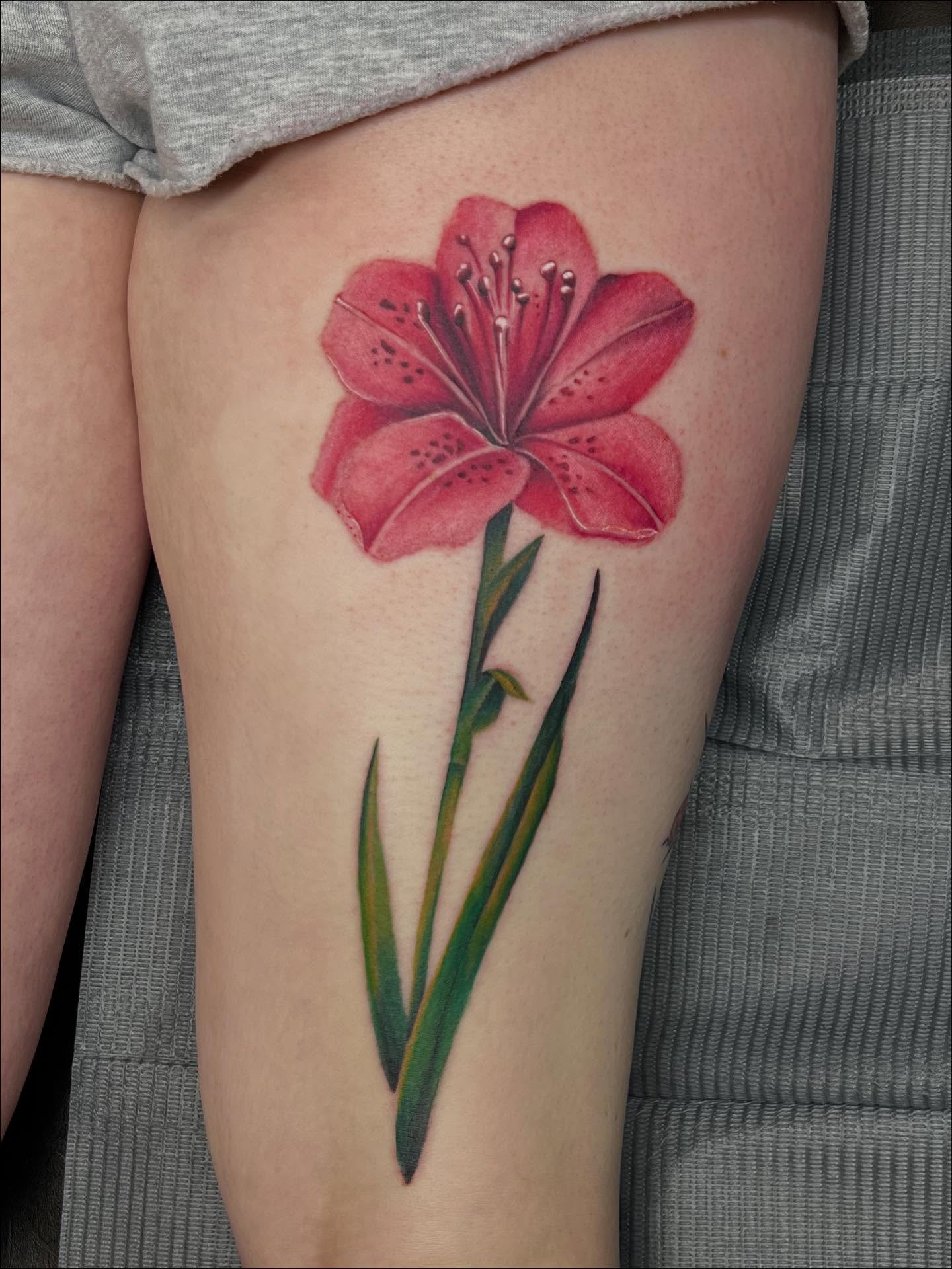 Lily realism tattoo on the thigh by Ebony Robinson, Austintown, Ohio