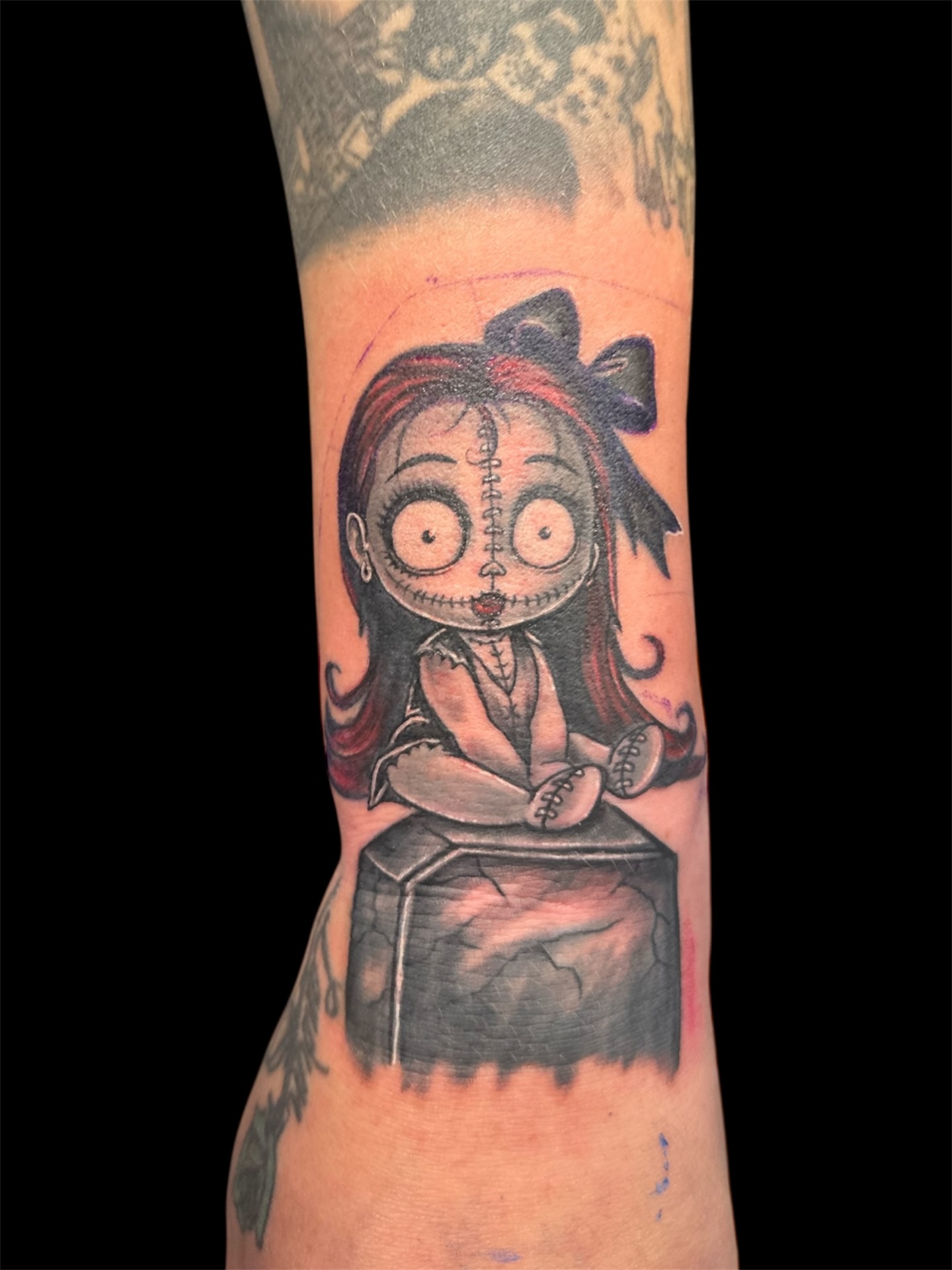 Doll black and grey tattoo on the forearm by Joe 💭👁