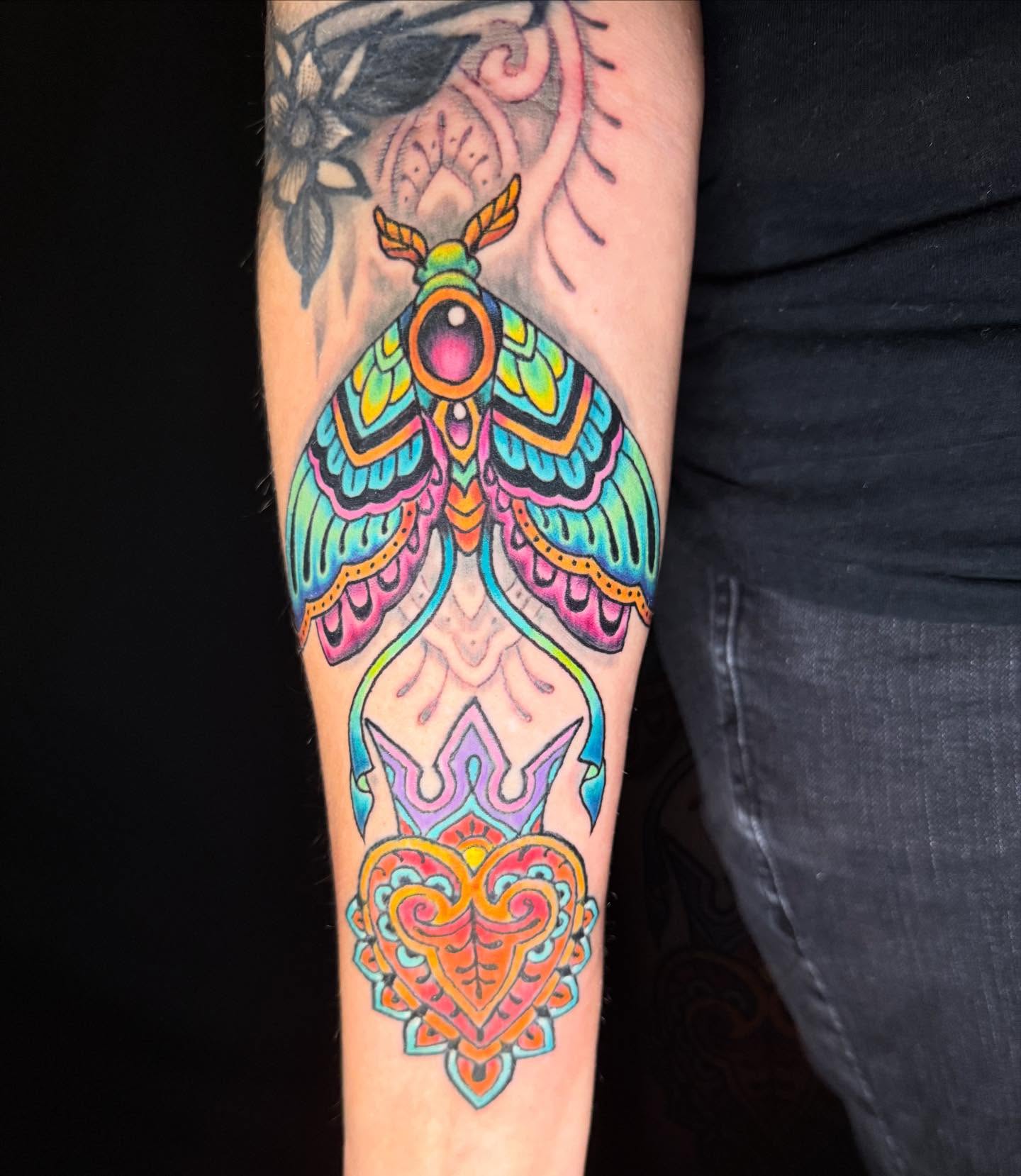 Moth and heart geometric tattoo on the forearm by Patrick Cornolo