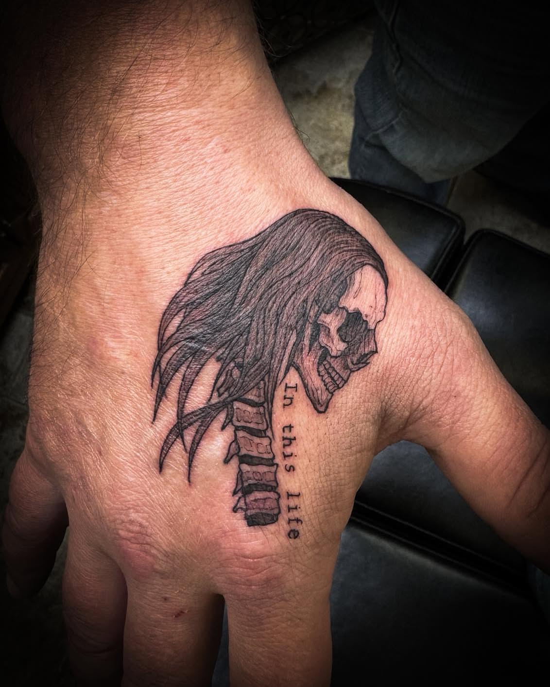 Skull with long hair dark realism tattoo on the hand by 𝔻𝕖𝕣𝕣𝕚𝕔𝕜 𝔹𝕦𝕪𝕖𝕒, East Aurora, New York