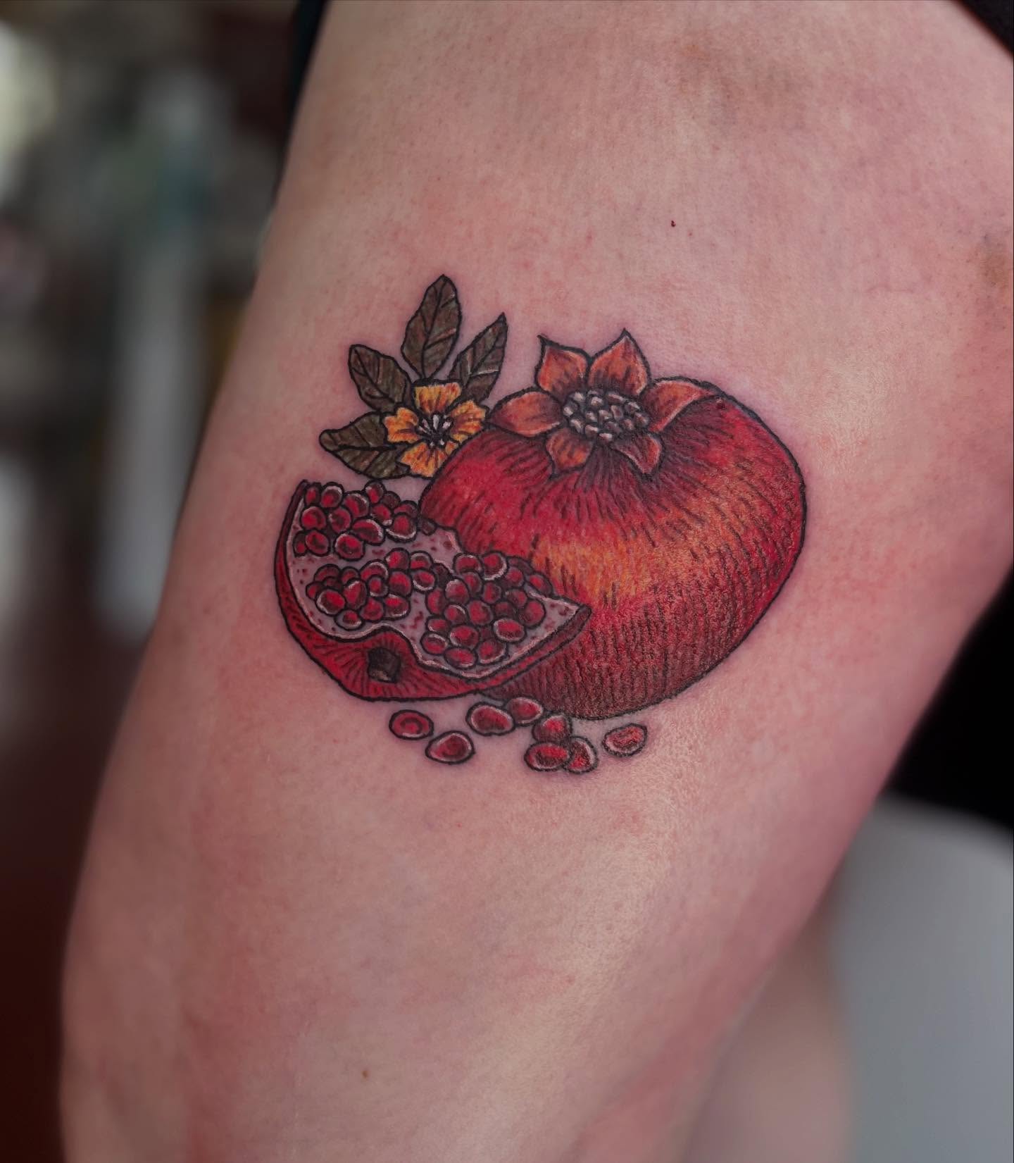 Pomegranate realism tattoo on the forearm by Rafaela Lopez