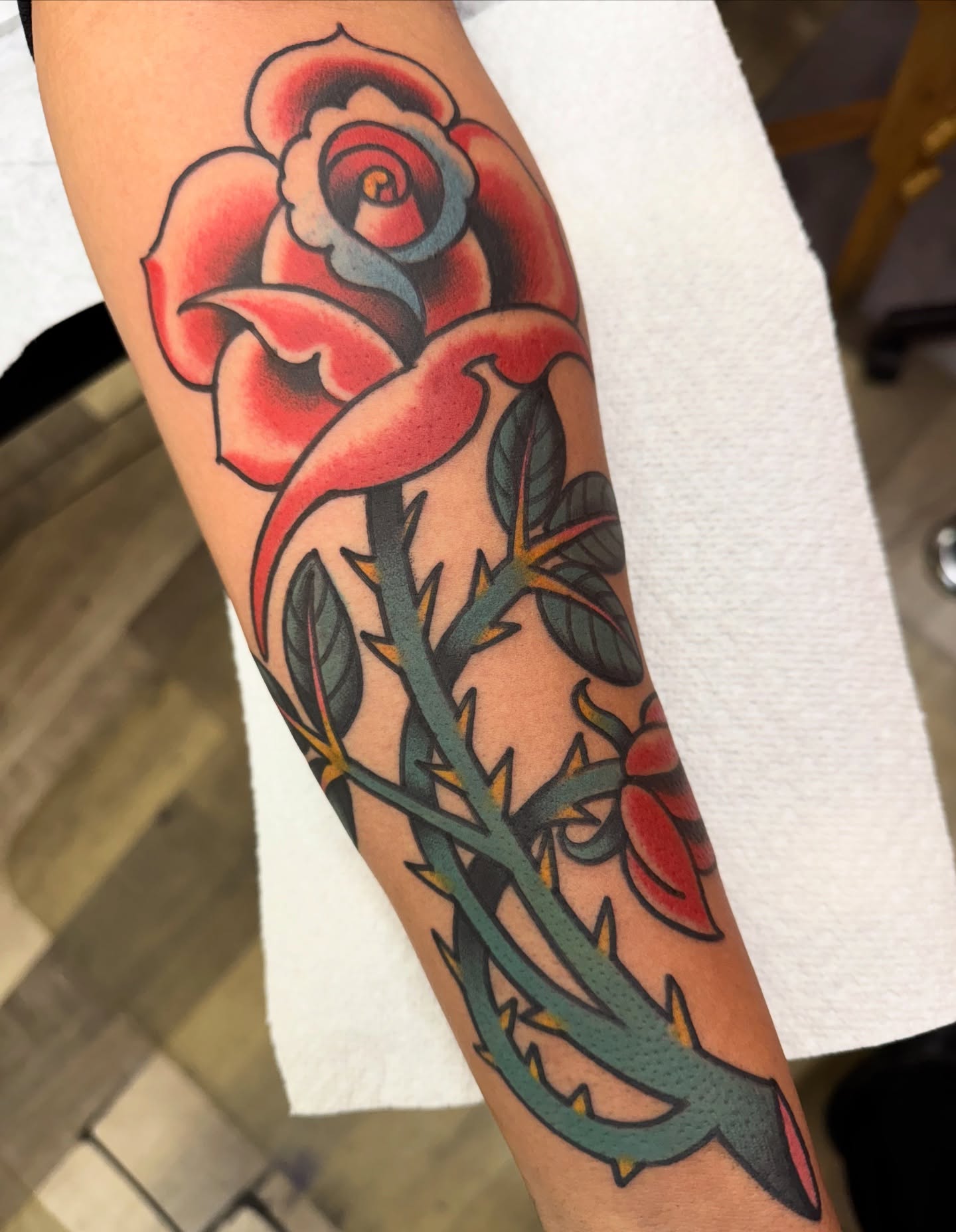 Rose American traditional tattoo on the forearm by Chris Orta