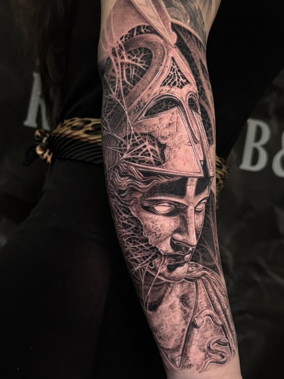 Helmeted warrior realism tattoo on the forearm by Dan Sprague