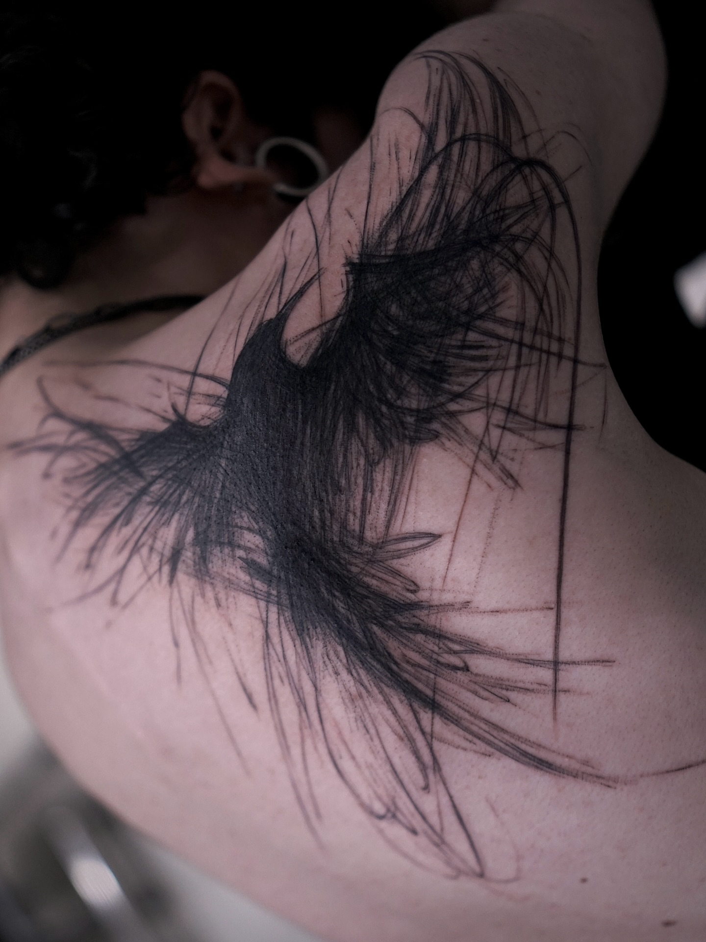 Feather black and grey tattoo on the shoulder by Young one 영원