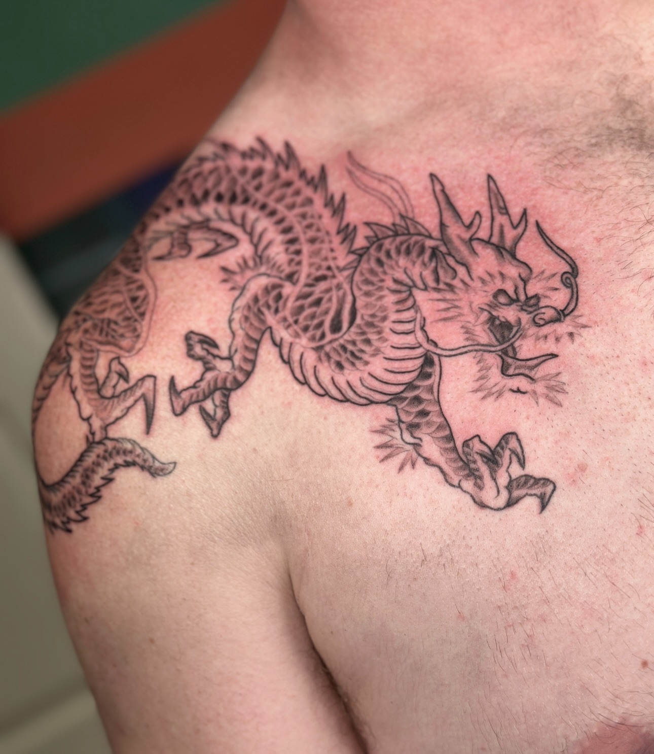 Dragon black and grey tattoo on the chest by Nashville Tattoo Artist - Nicolette Madlyne