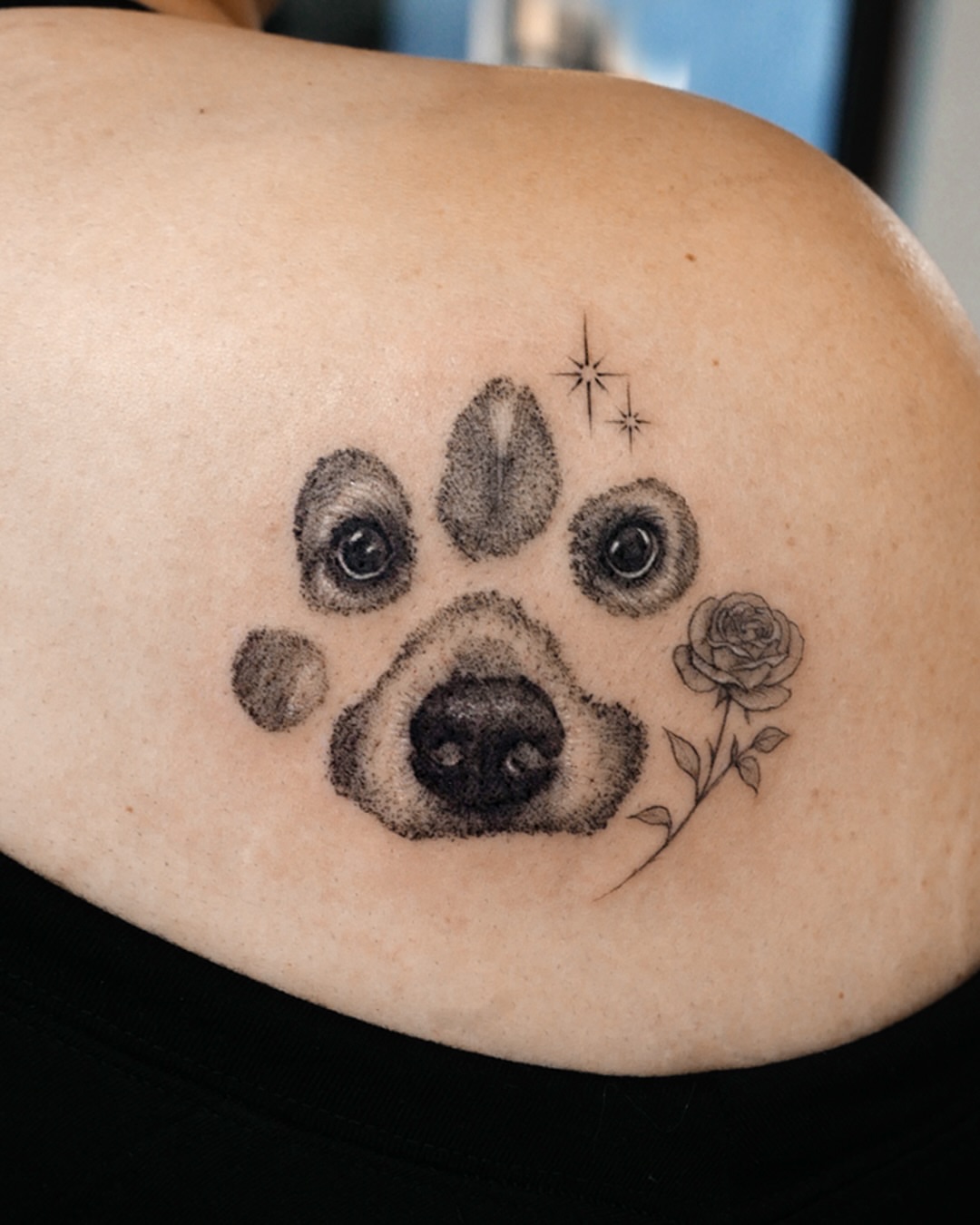 Dog paw print with rose dotwork tattoo on the shoulder by Ria Kim 김리아