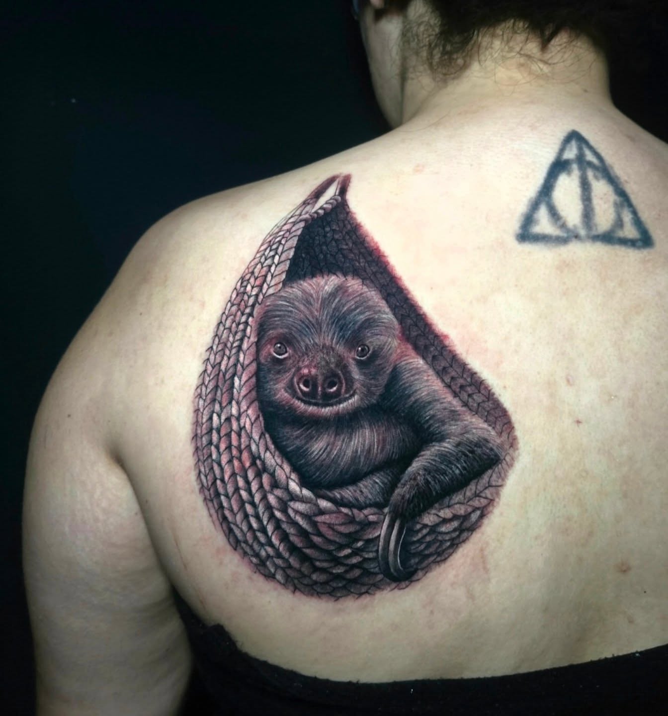 Sloth in hammock realism tattoo on the back by Anna Brittany
