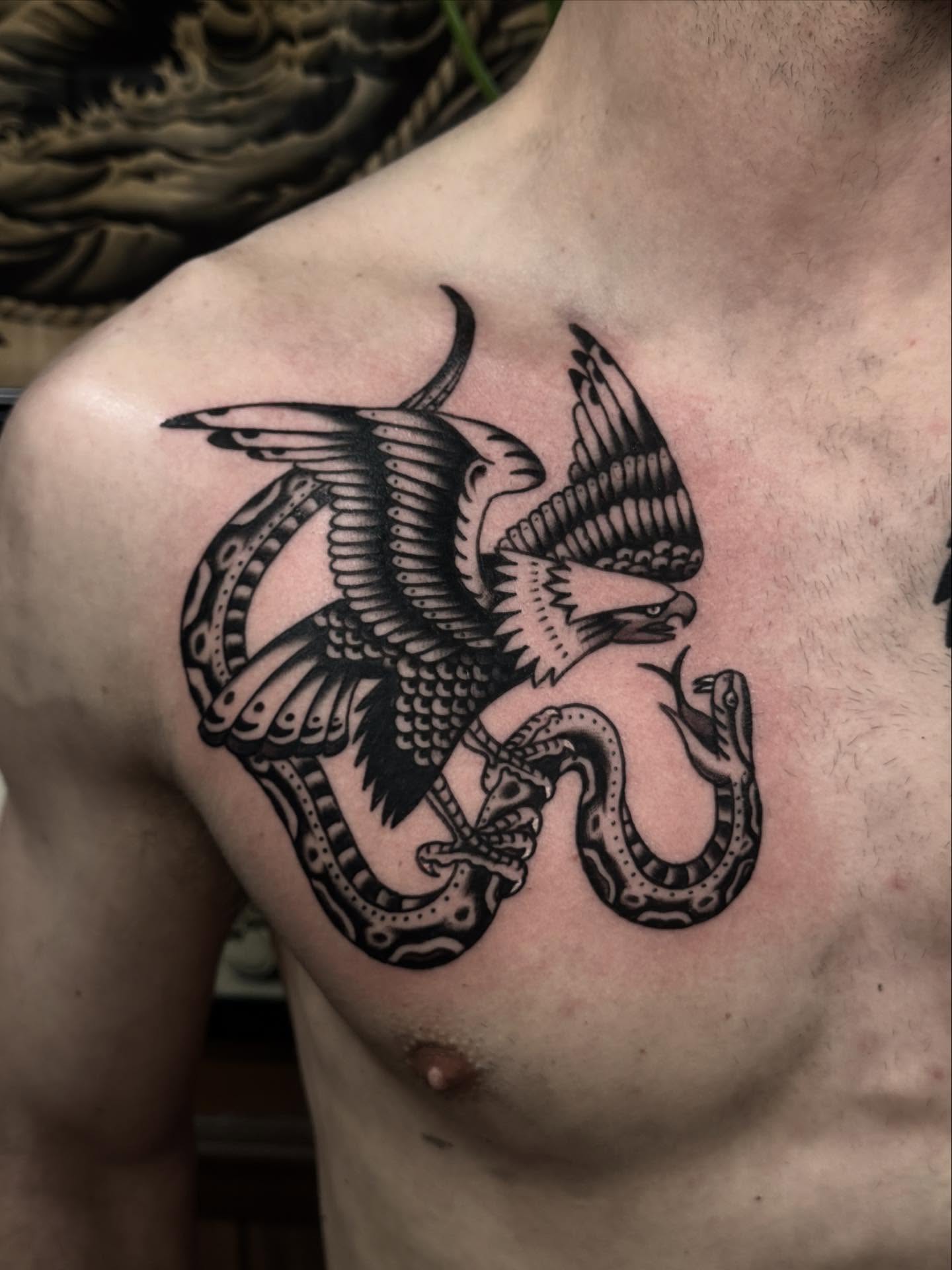 Eagle and snake black and grey tattoo on the chest by Ryan Engels