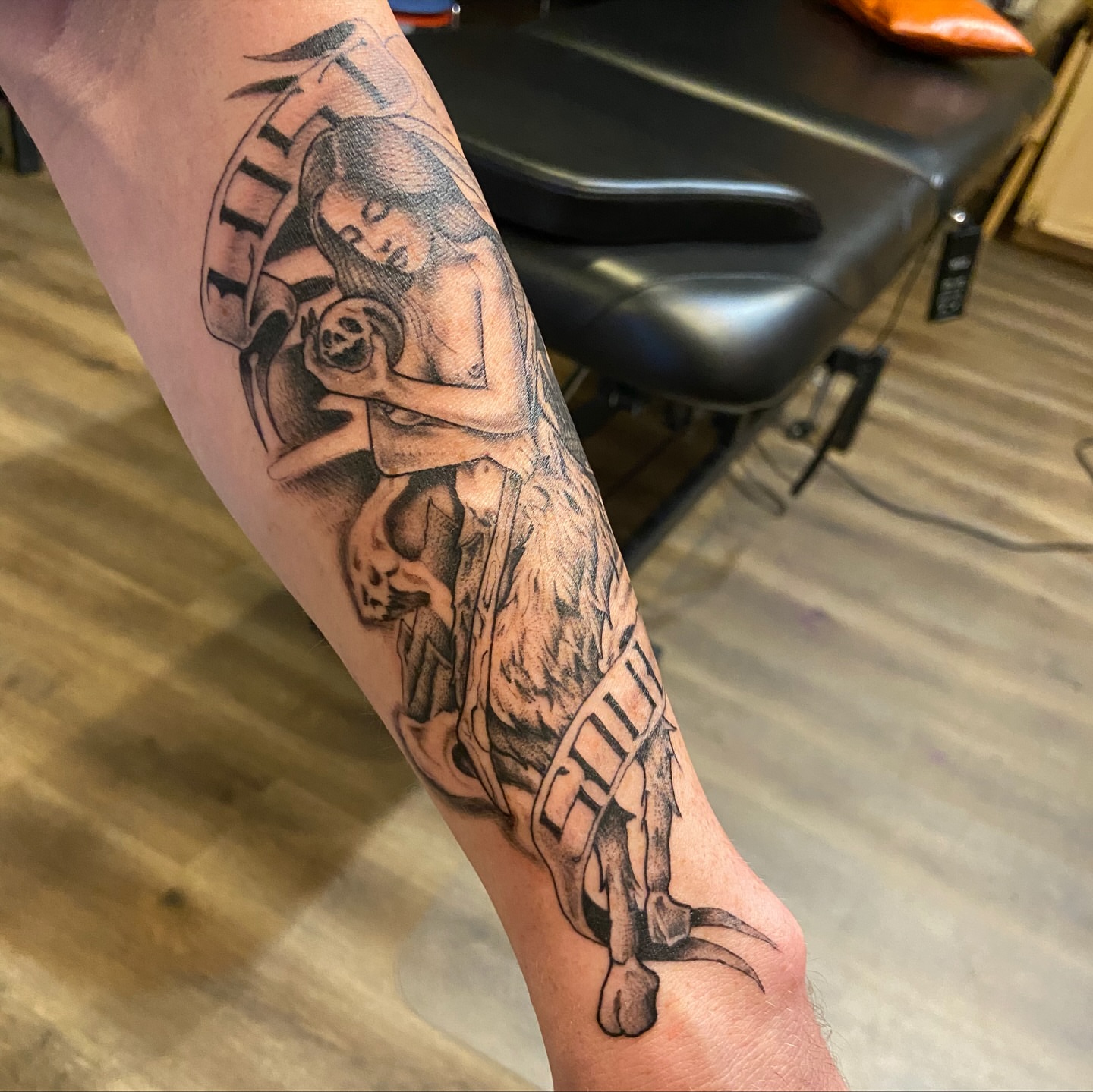 Woman holding skull American traditional tattoo on the forearm by Anthony Robles