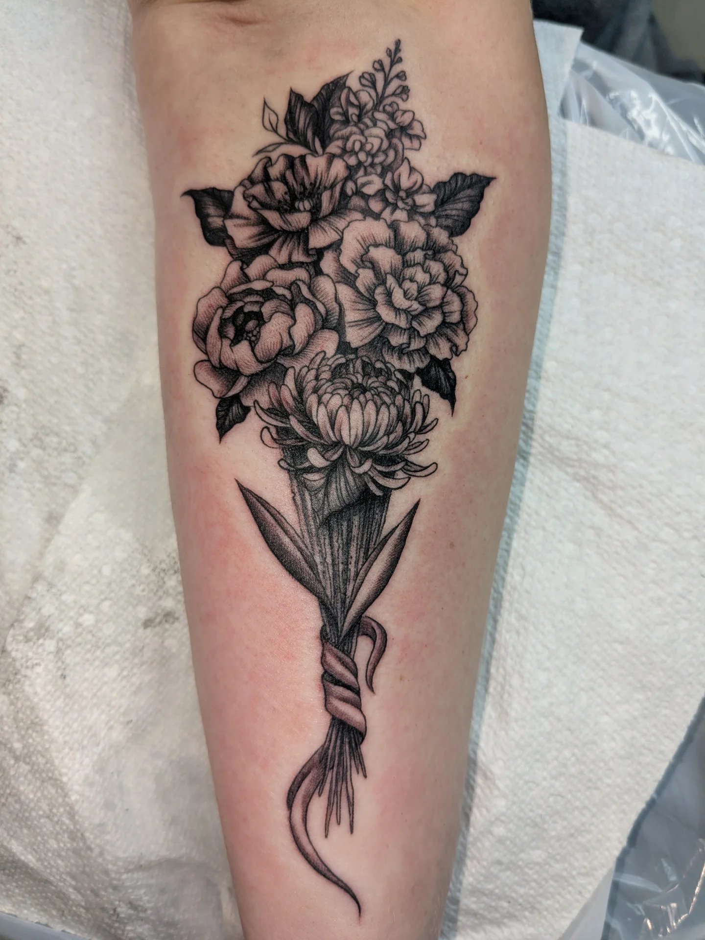 Flower bouquet black and grey tattoo on the forearm by Jessica Thomas Fleischman, Morganton, North Carolina