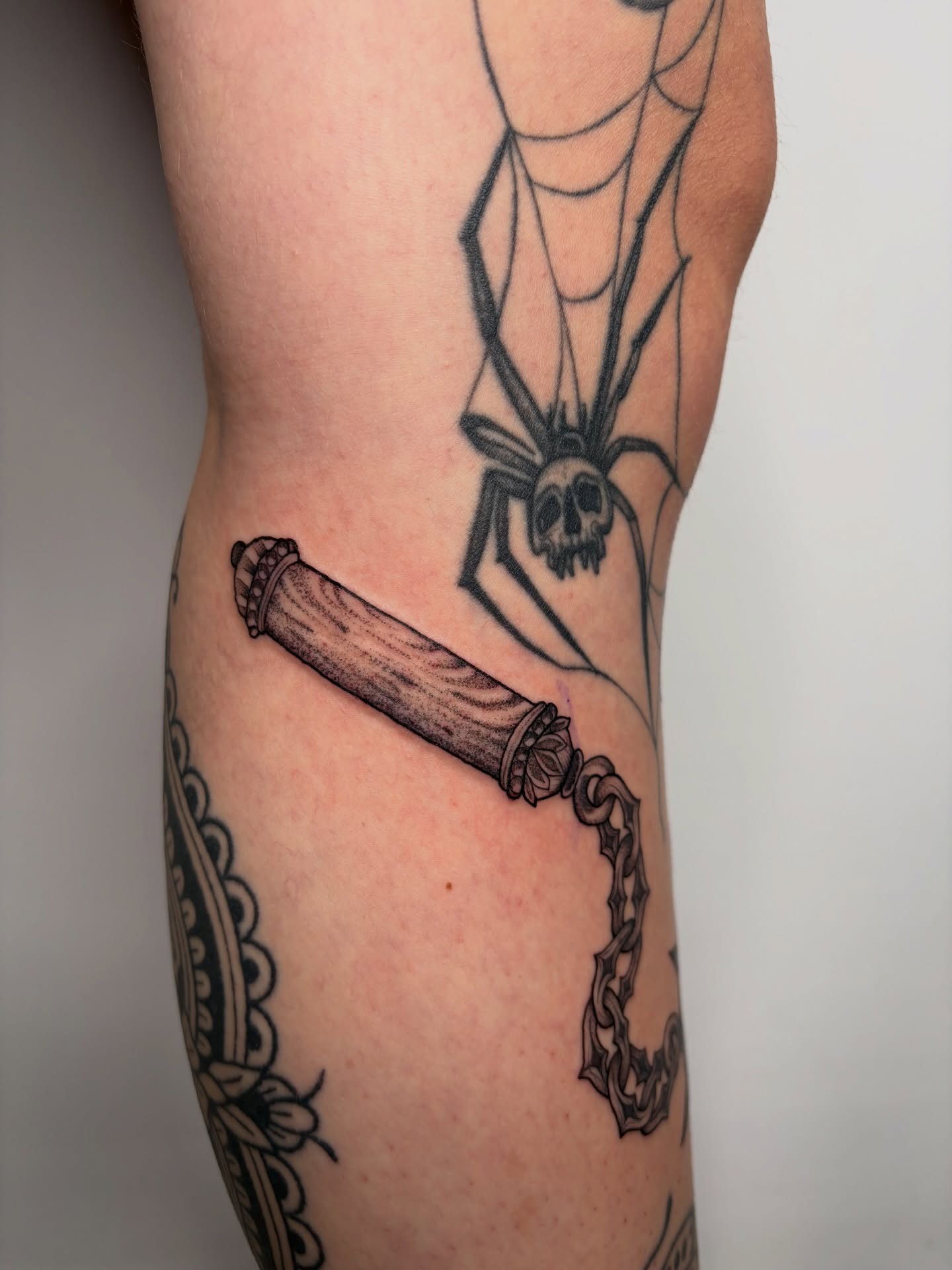 Knife and spider black and grey tattoo on the forearm by Poppy Olivia Deards