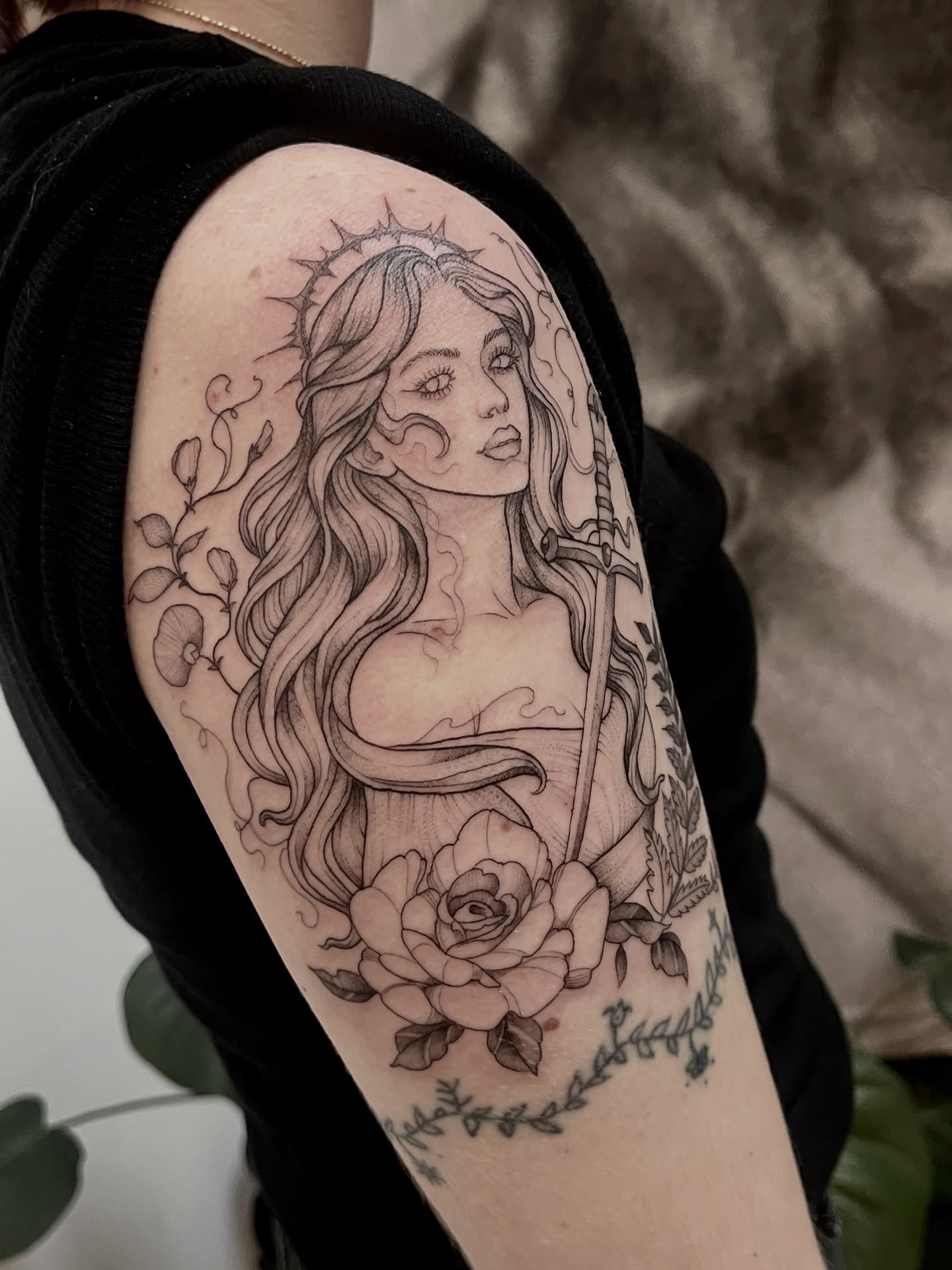 Woman with sword and roses realism tattoo on the forearm by Lo Gwynn