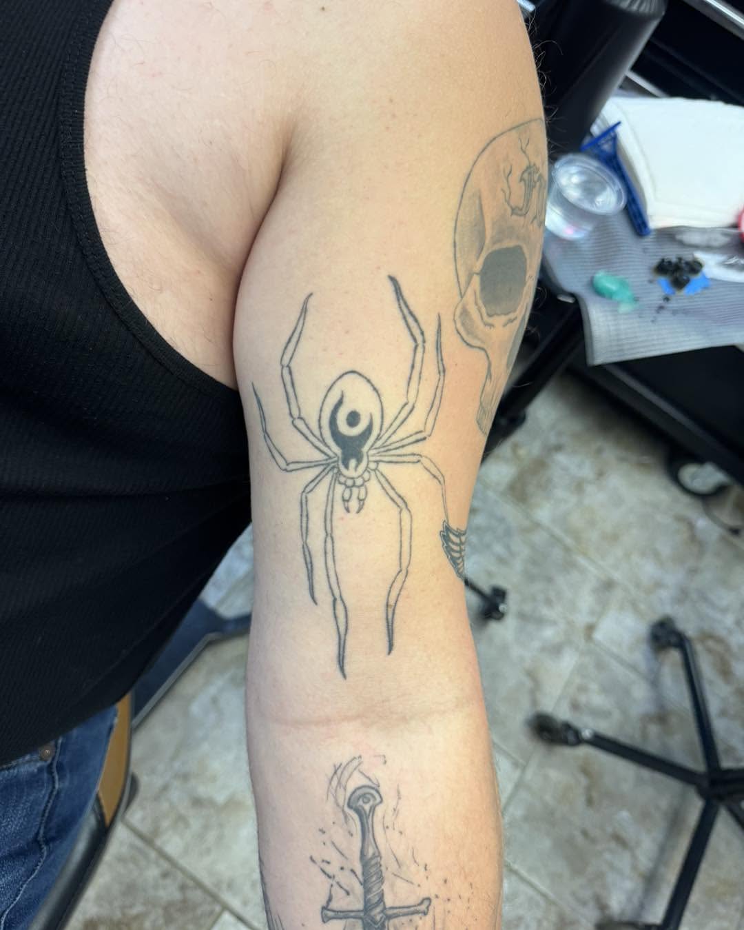 Spider black and grey tattoo on the forearm by 𝔻𝕖𝕣𝕣𝕚𝕔𝕜 𝔹𝕦𝕪𝕖𝕒, East Aurora, New York