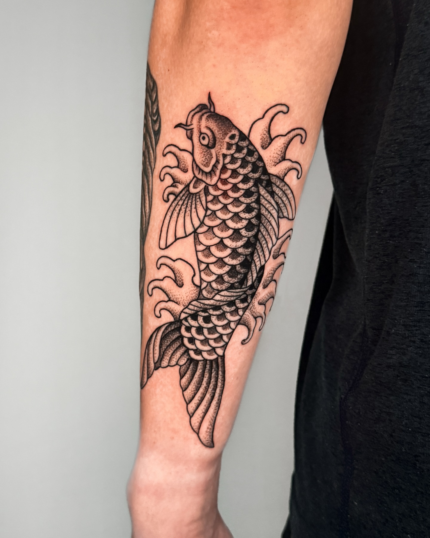 Koi fish dotwork tattoo on the forearm by Jae Traditional Tattoo