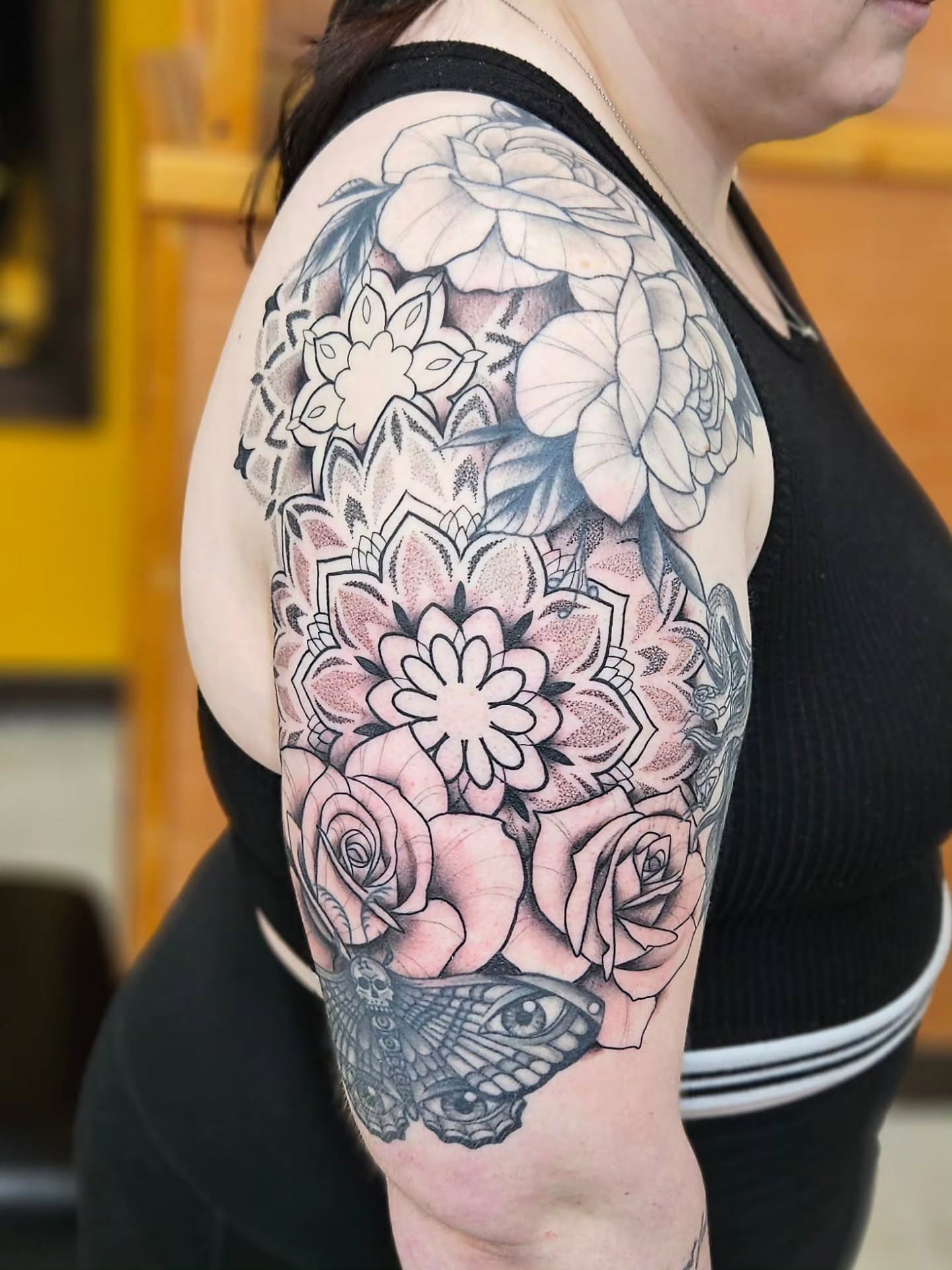 Floral arrangement geometric tattoo on the upper arm by Jordanna Pearl