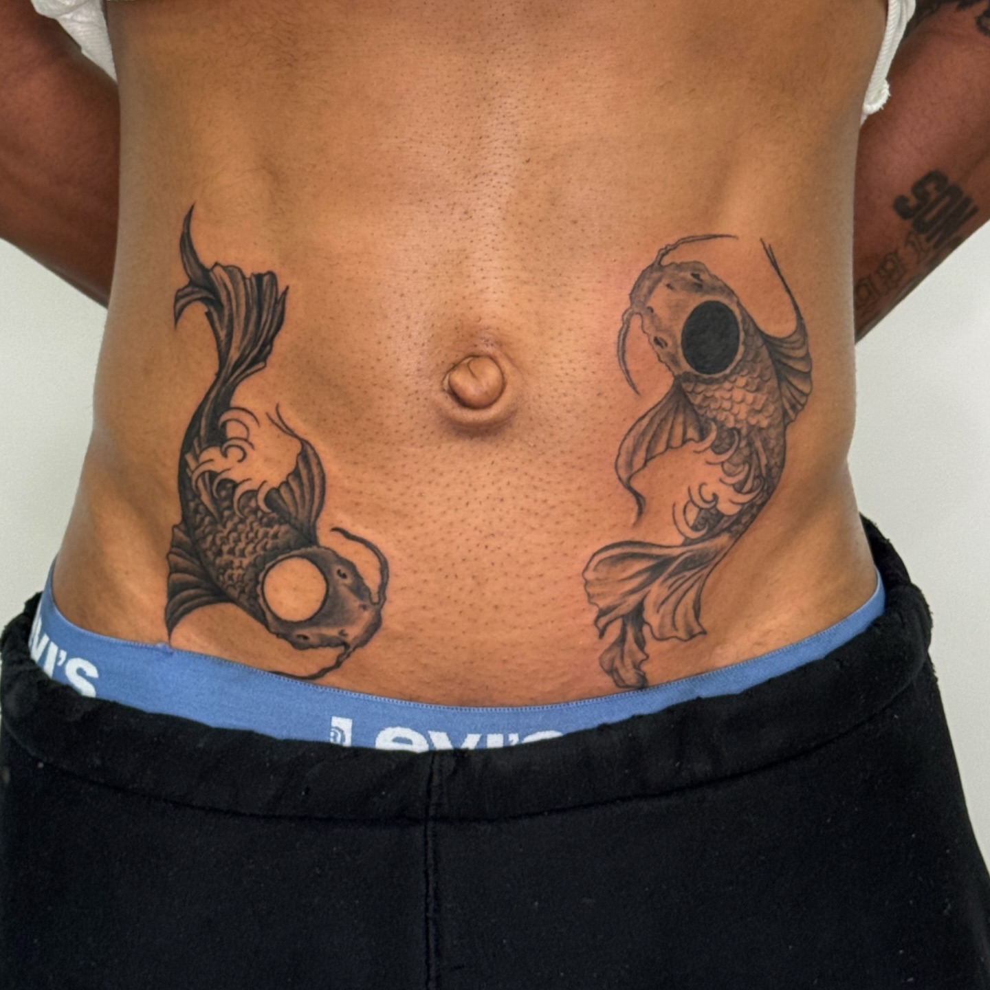 Koi fish black and grey tattoo on the torso by Tiffany