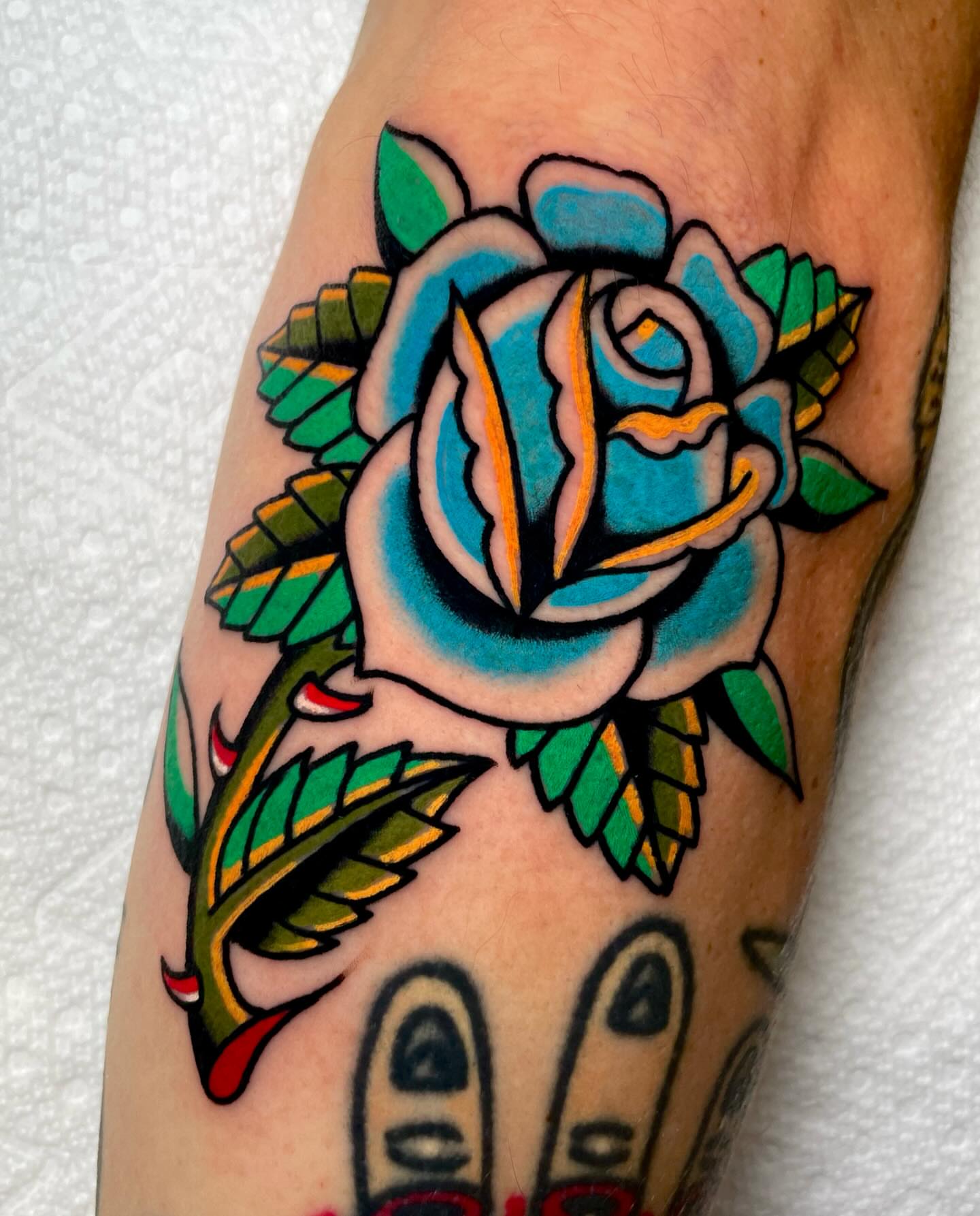 Rose American traditional tattoo on the forearm by Ryan McDonald