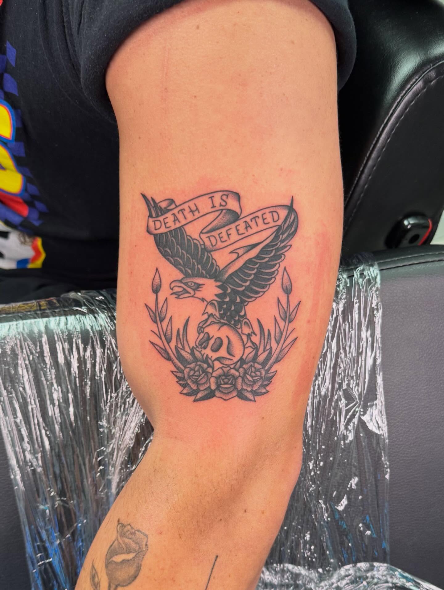 Death defeated black and grey tattoo on the forearm by haylie