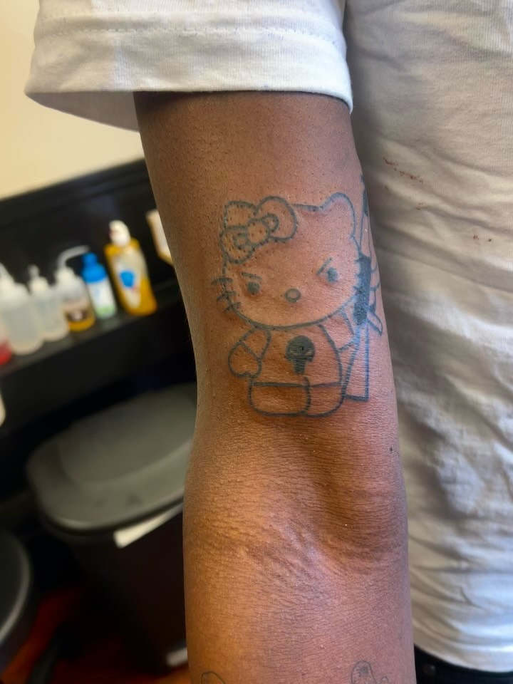 Hello Kitty dotwork tattoo on the forearm by Chris